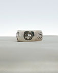 Gucci Blind for Love sterling silver ring featuring an engraved motif band in size 6, displayed on a soft fabric background.