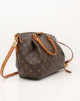 Brown handbag with gold accents on a white background