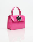 Pink patent leather Philipp Plein handbag with top handle and gold accents, stylishly displayed against a neutral background.