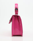 Pink patent top handle handbag by Philipp Plein with gold accents, stylish and elegant for everyday or special occasions.