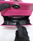 Pink patent leather handbag with top handle by Philipp Plein, featuring gold accents and a sleek, stylish design.