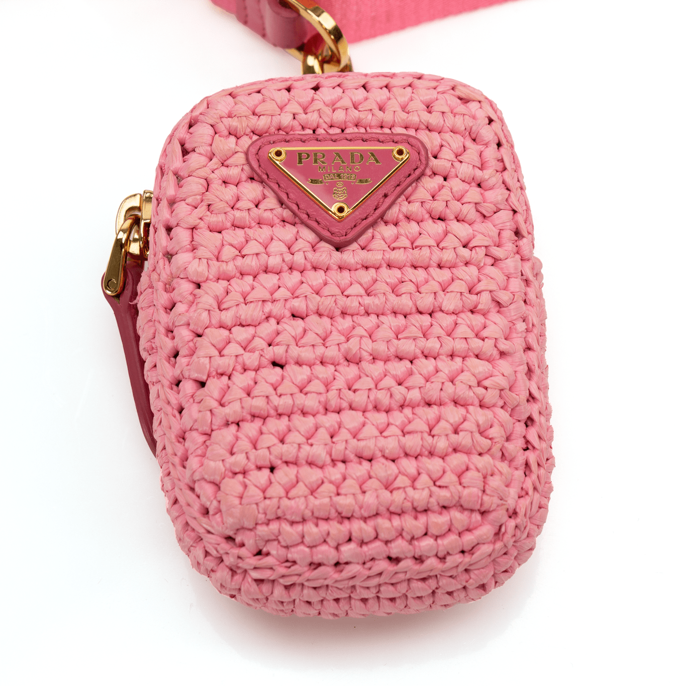 Pink Prada 2005 Re-Edition crochet handbag by Gold & Beyond, featuring a textured woven design and stylish hand-carry handle.