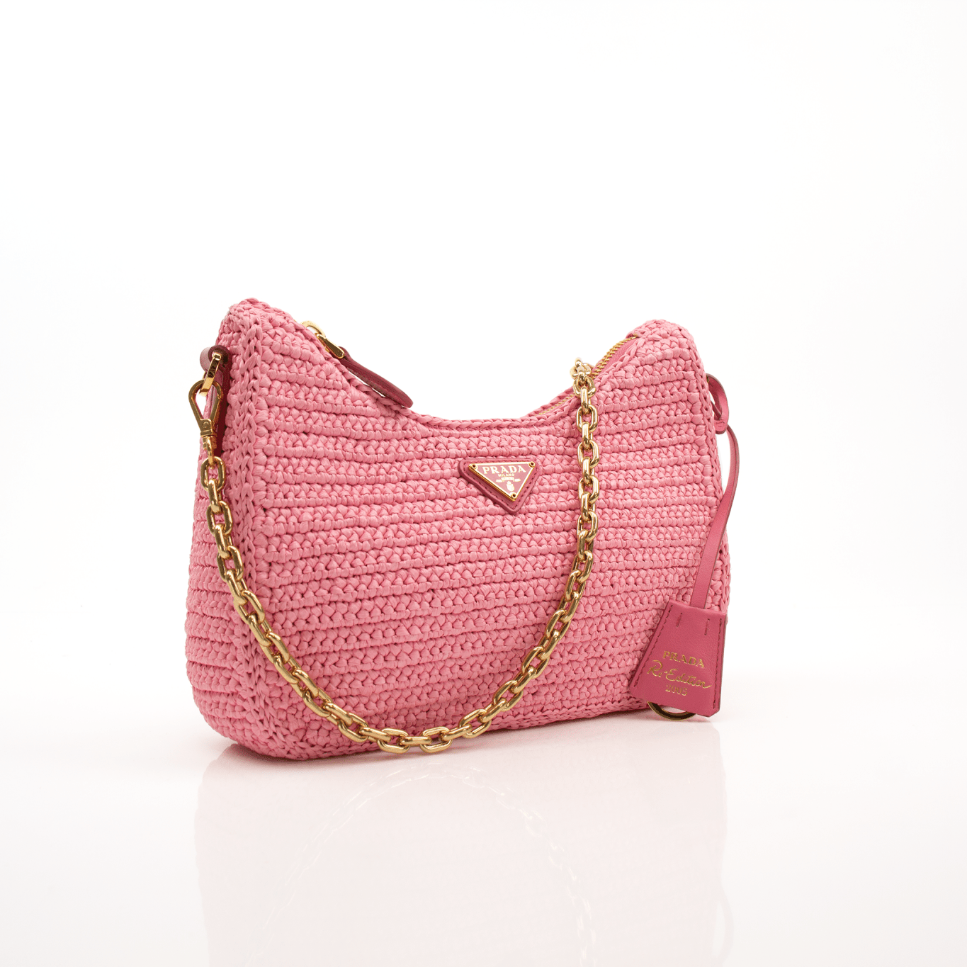 Pink Prada 2005 Re-Edition crochet handbag by Gold & Beyond, featuring a textured crochet design and stylish hand-held shape.