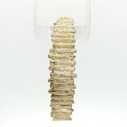 14K yellow gold brutalist textured bangle bracelet with modern, artistic design showcasing bold, rugged jewelry style.