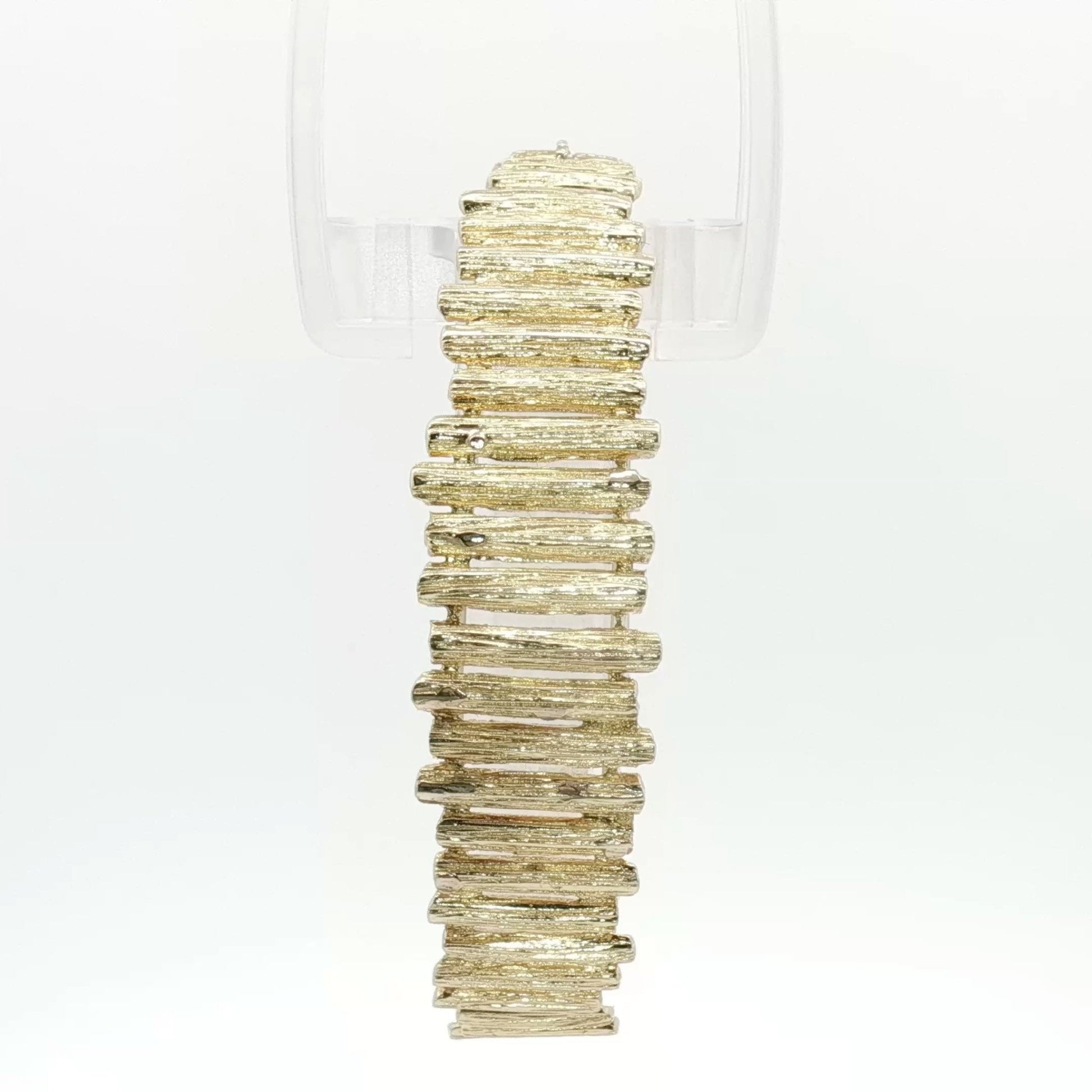 14K yellow gold brutalist textured bangle bracelet showcasing modern jewelry design and craftsmanship.