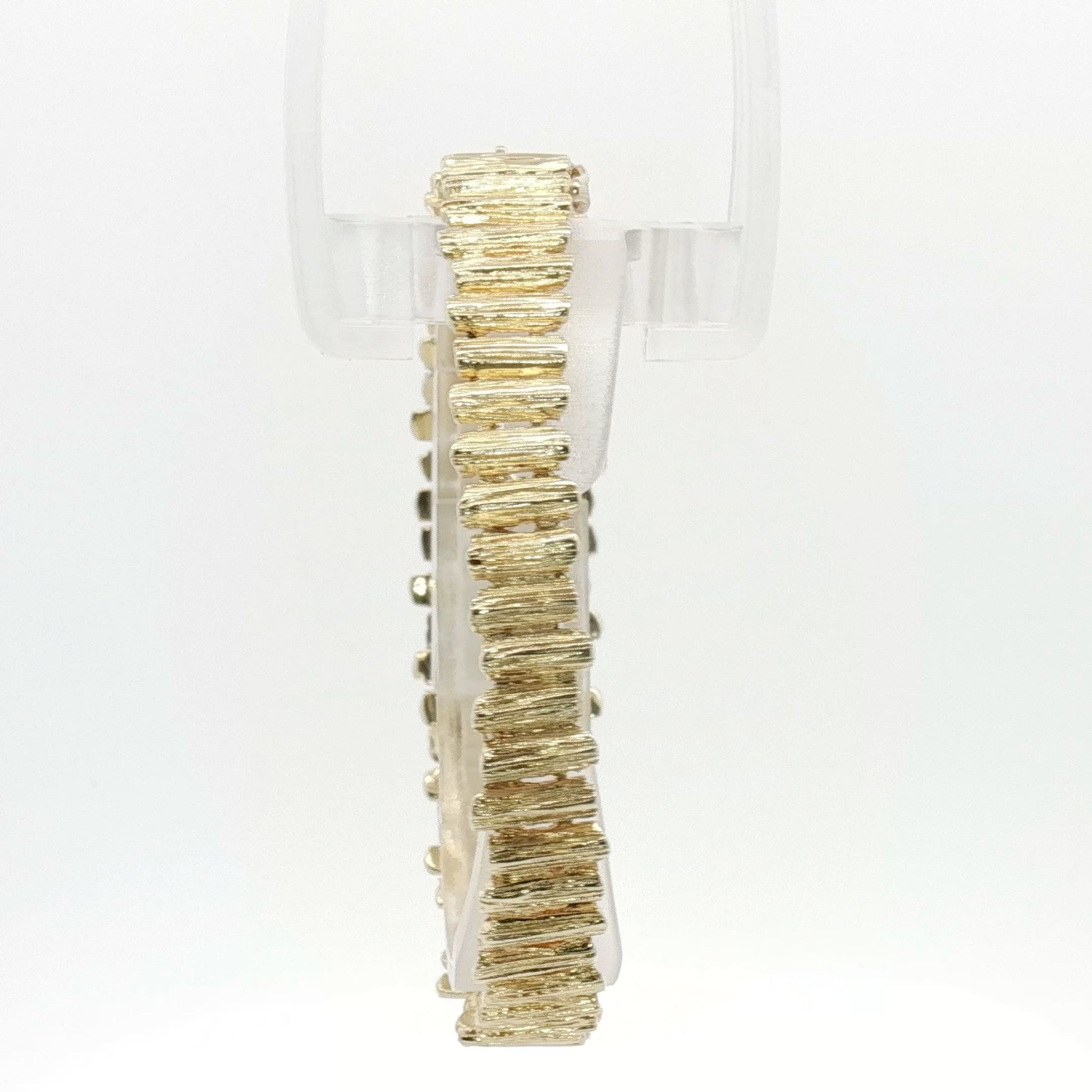 14K yellow gold brutalist textured bangle bracelet with modern, artistic design, showcasing unique craftsmanship and bold style.