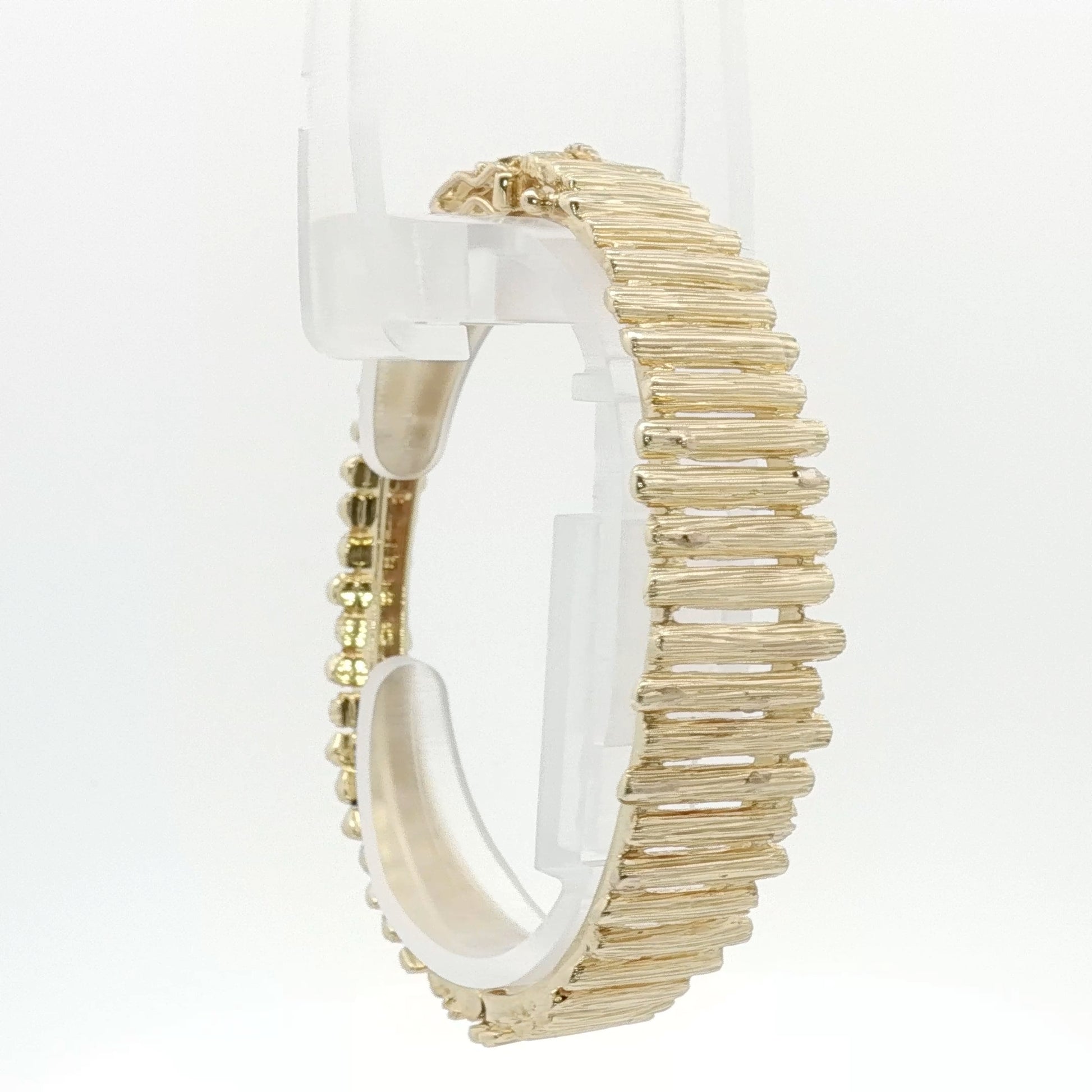 14K yellow gold brutalist textured bangle bracelet with modern, rugged design from Gold & Beyond jewelry collection.