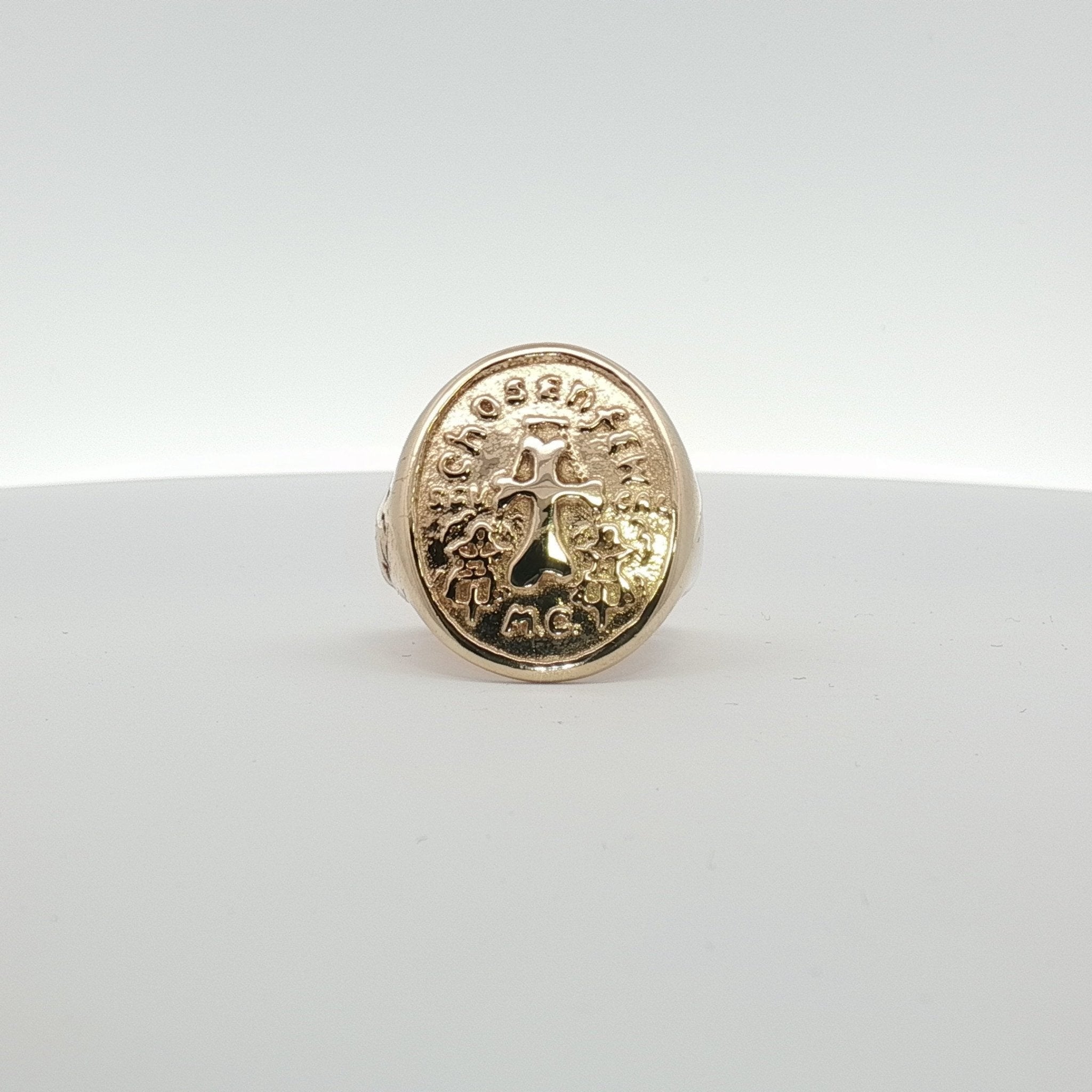 14K yellow gold cross coin ring with detailed religious design, jewelry piece from Gold & Beyond, close-up shot.