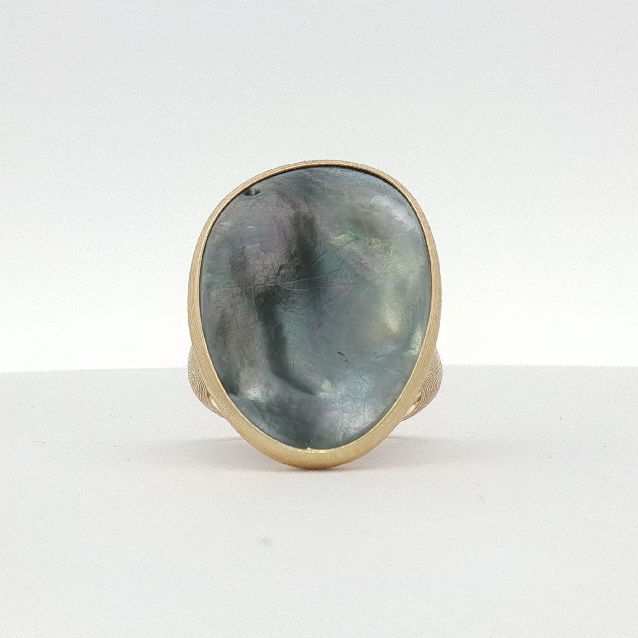 18K yellow gold Marco Bicego Lunaria ring with black mother of pearl, elegant jewelry piece with intricate design.
