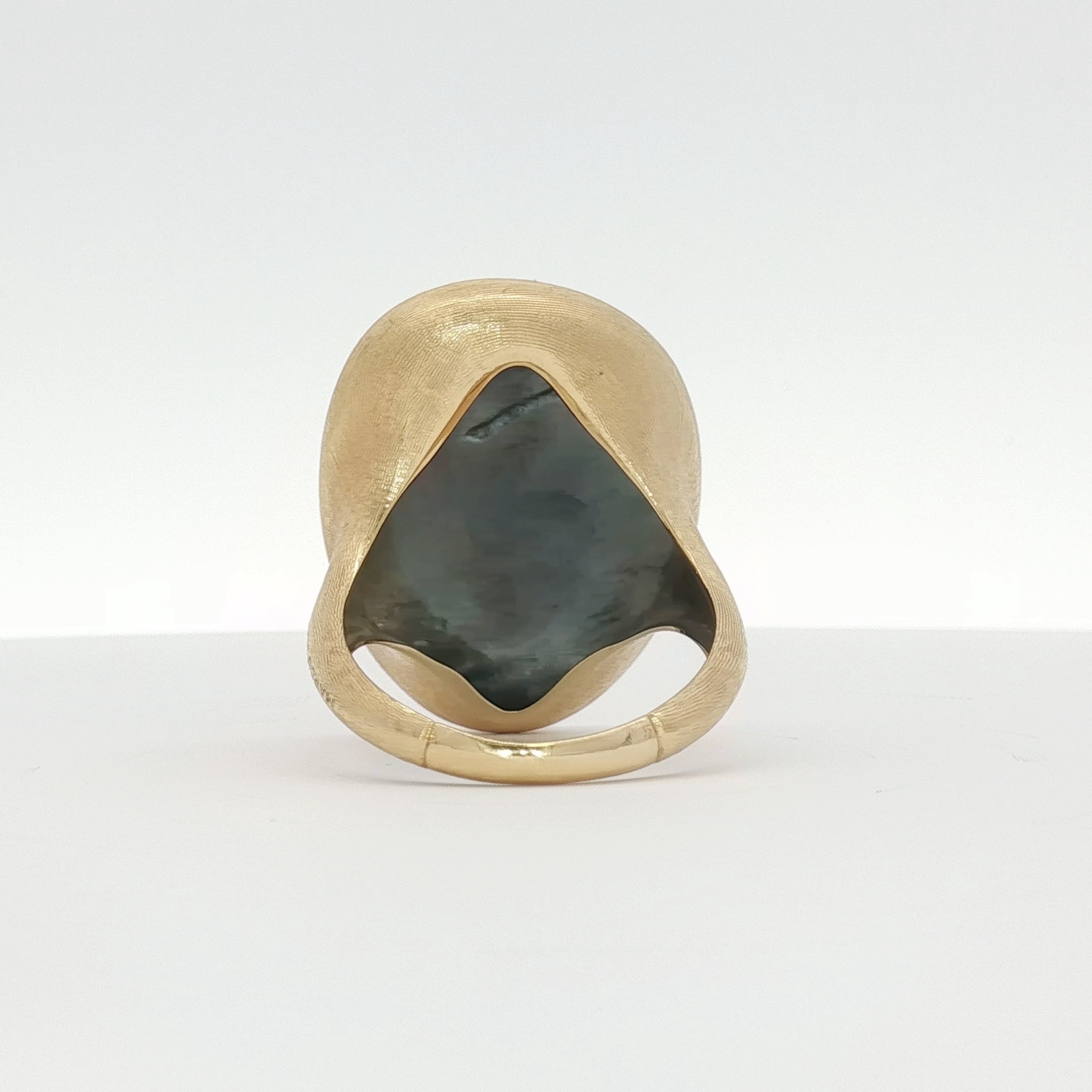 18K yellow gold Marco Bicego Lunaria black mother of pearl ring, elegant jewelry with intricate gold detailing and shiny pearl surface.
