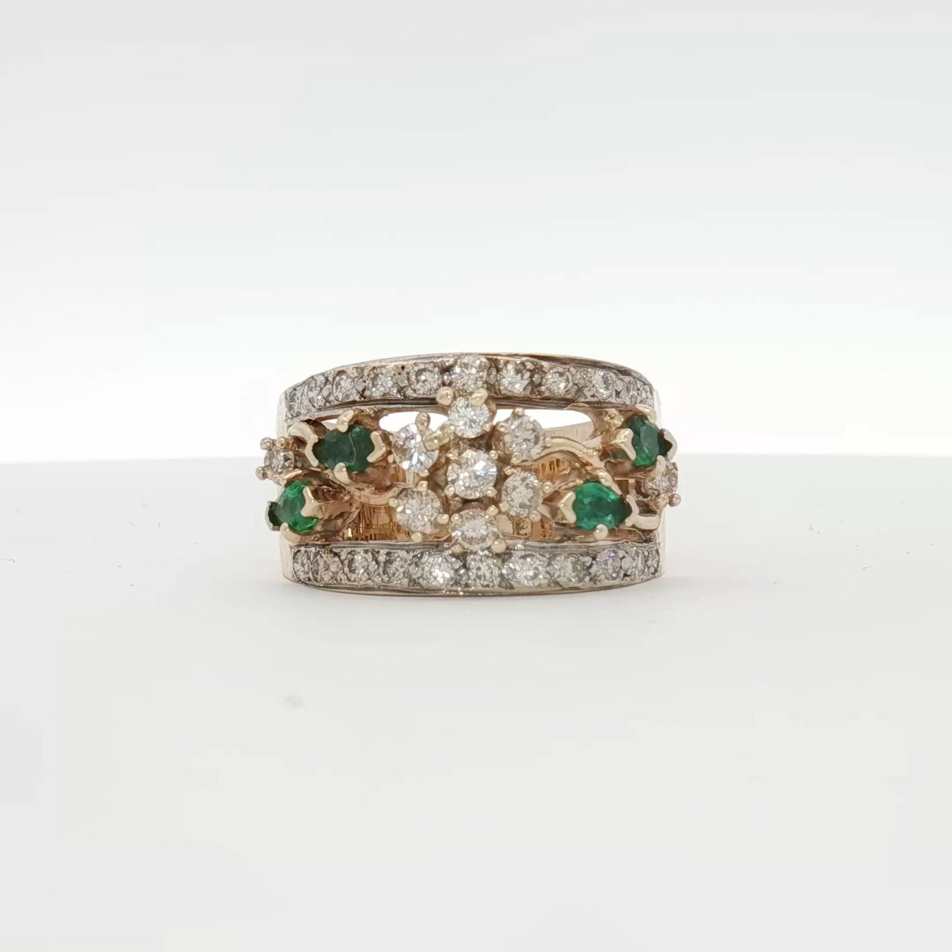 10K yellow gold emerald and diamond flower cluster ring, showcasing intricate jewelry design with vibrant gemstones.