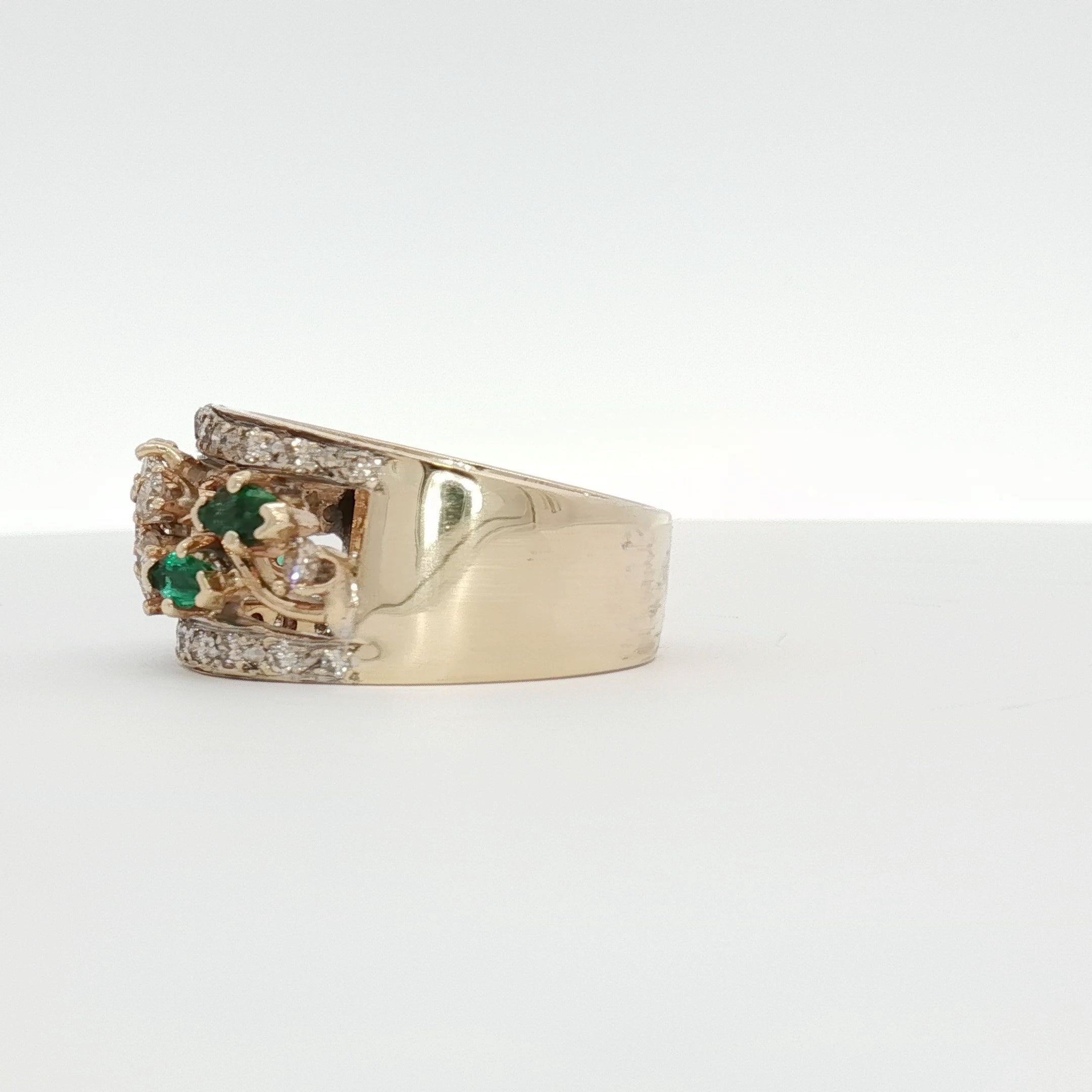 10K yellow gold emerald and diamond flower cluster ring featuring intricate jewelry design and sparkling gemstones.