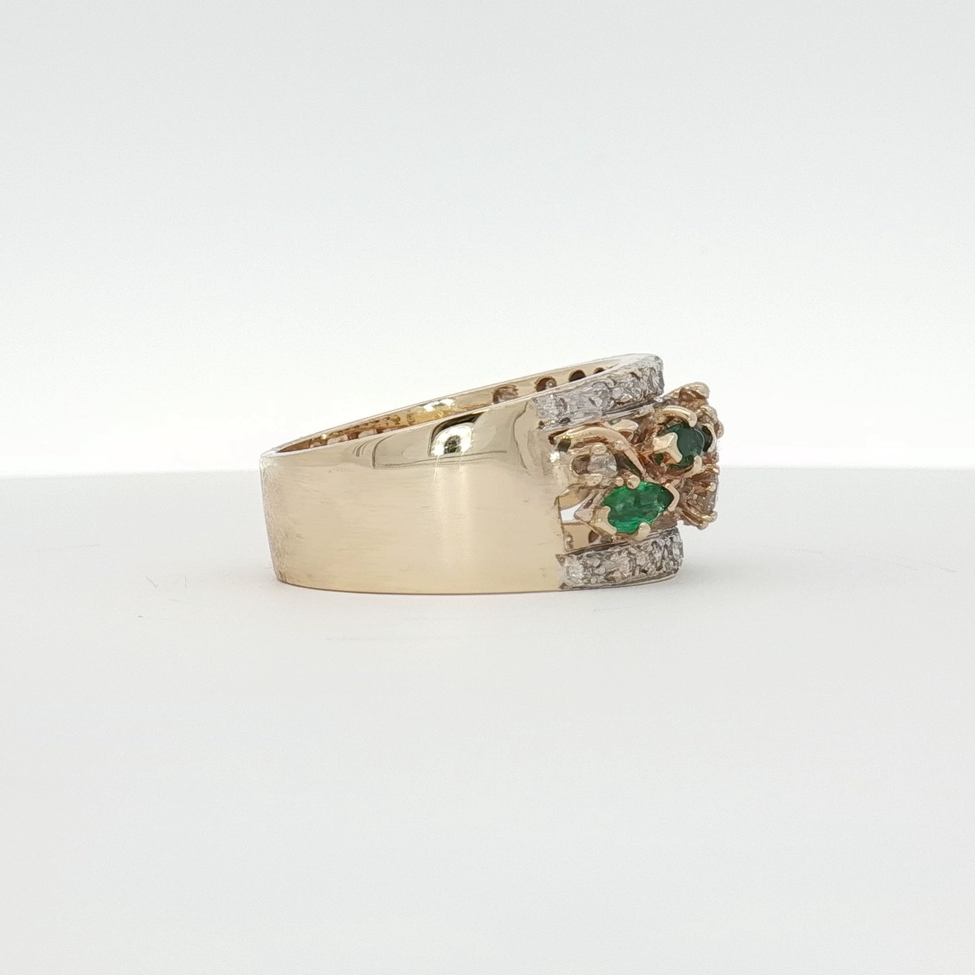 Yellow gold emerald and diamond flower cluster ring, showcasing a detailed jewelry design with vibrant gemstones and intricate craftsmanship.