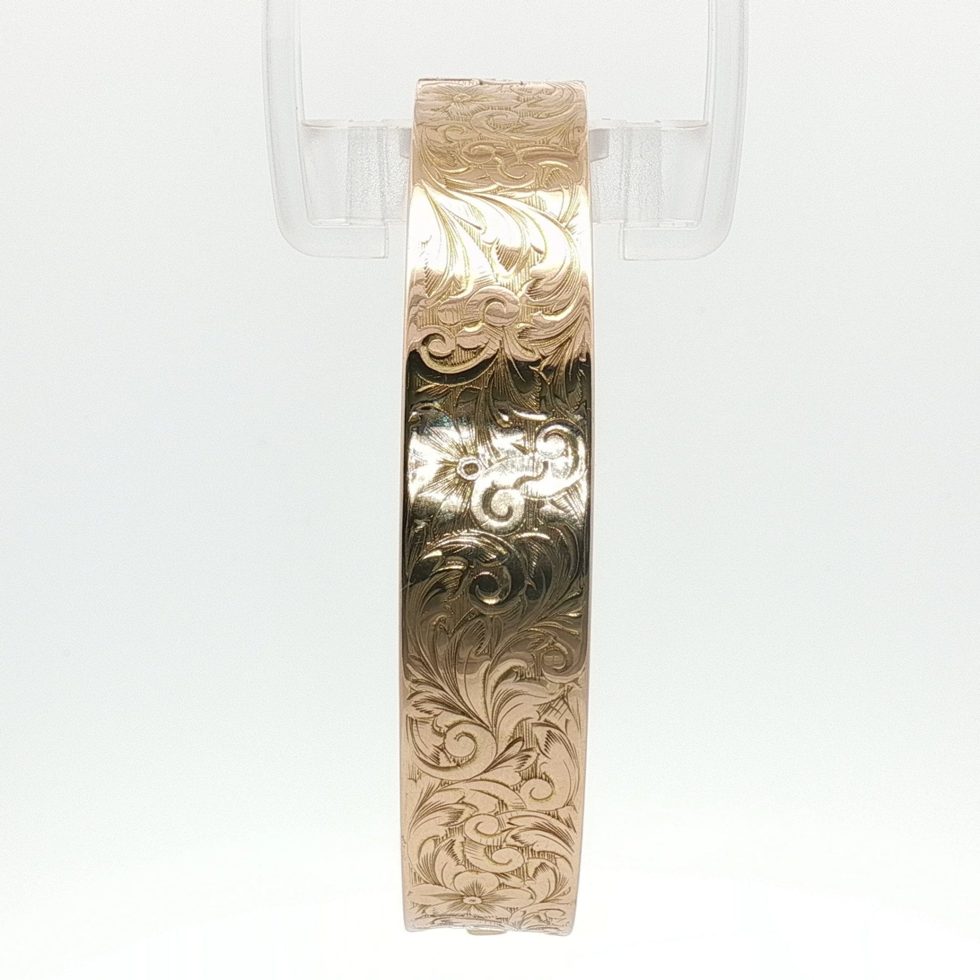 14K yellow gold engraved floral bangle bracelet with detailed floral design, crafted by Gold & Beyond.