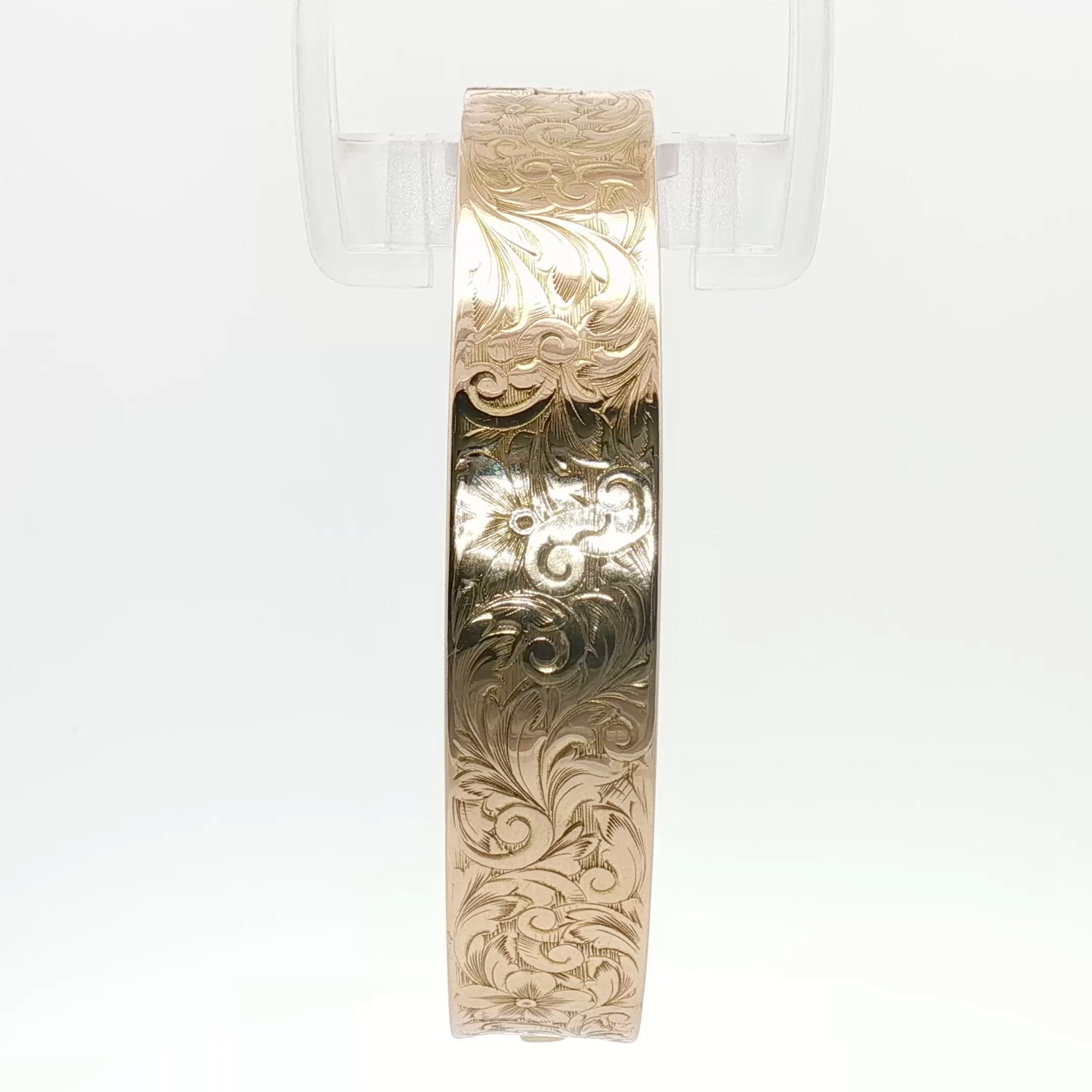 14K yellow gold engraved floral bangle bracelet with intricate floral patterns, jewelry from Gold & Beyond.