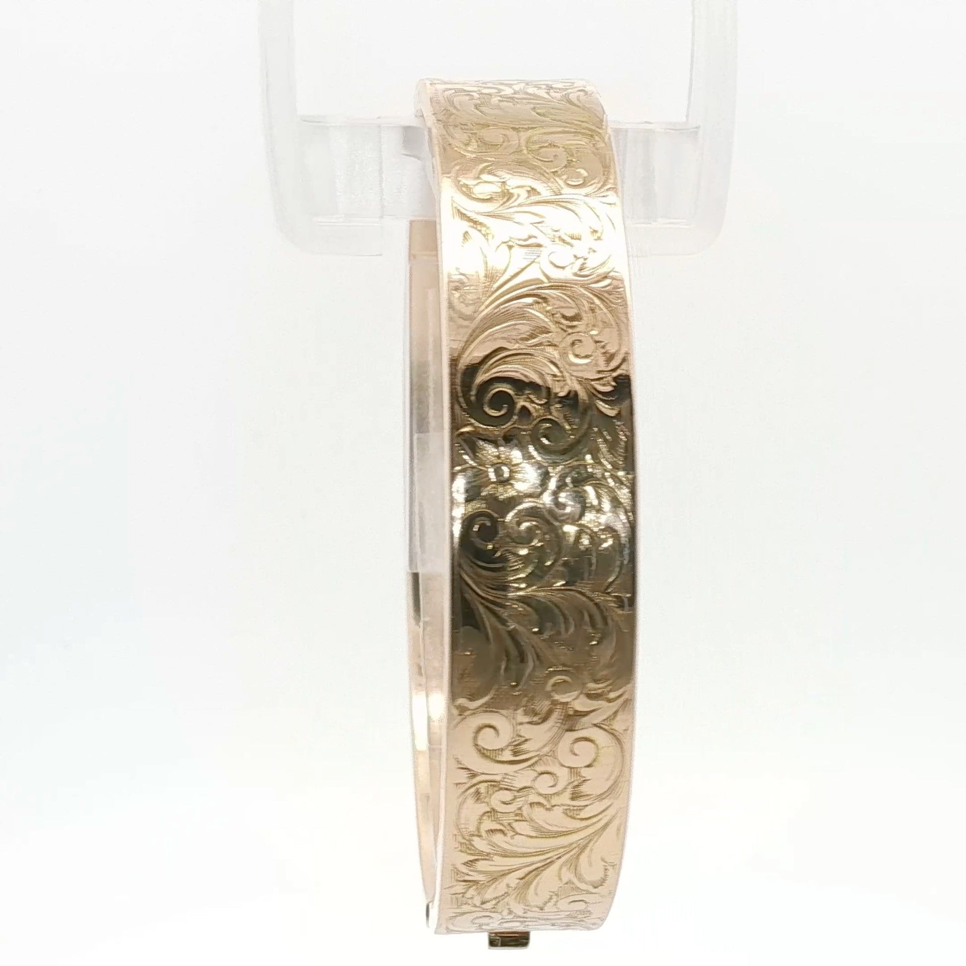 14K yellow gold engraved floral bangle bracelet with intricate floral patterns, showcasing fine jewelry craftsmanship.