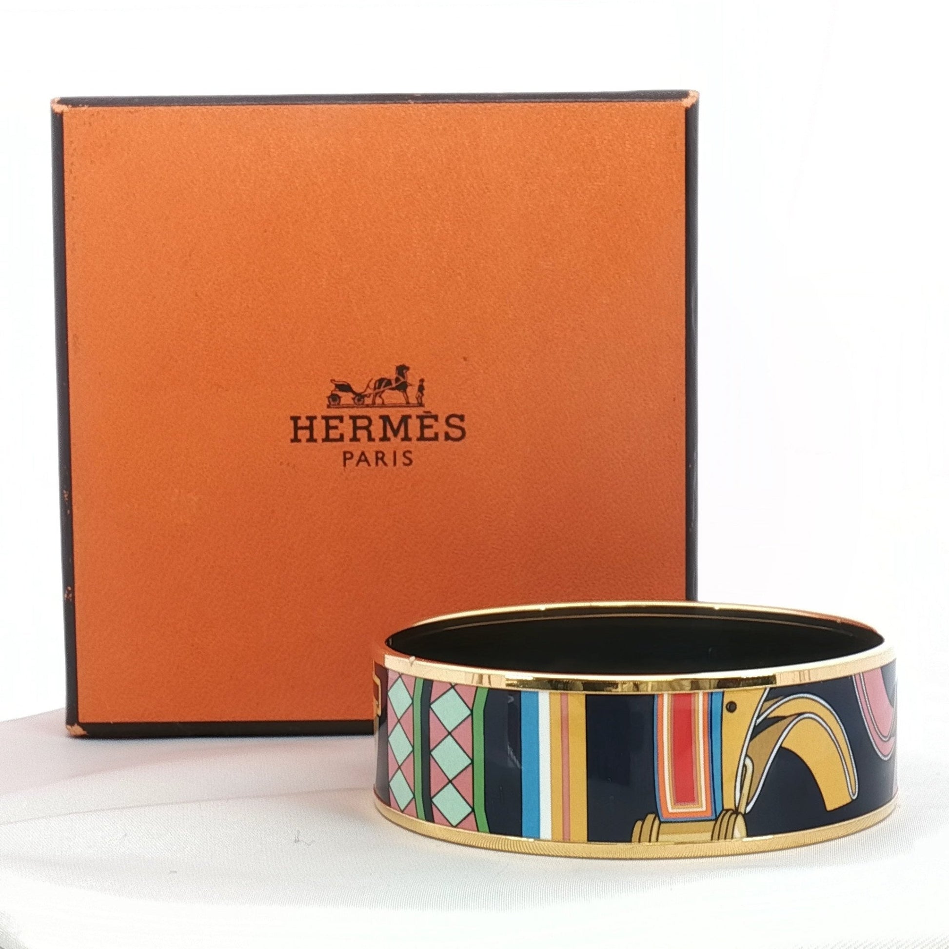 Hermès enamel bangle bracelet with colorful design, jewelry by Gold & Beyond, showcasing vibrant enamel details and sleek gold accents.