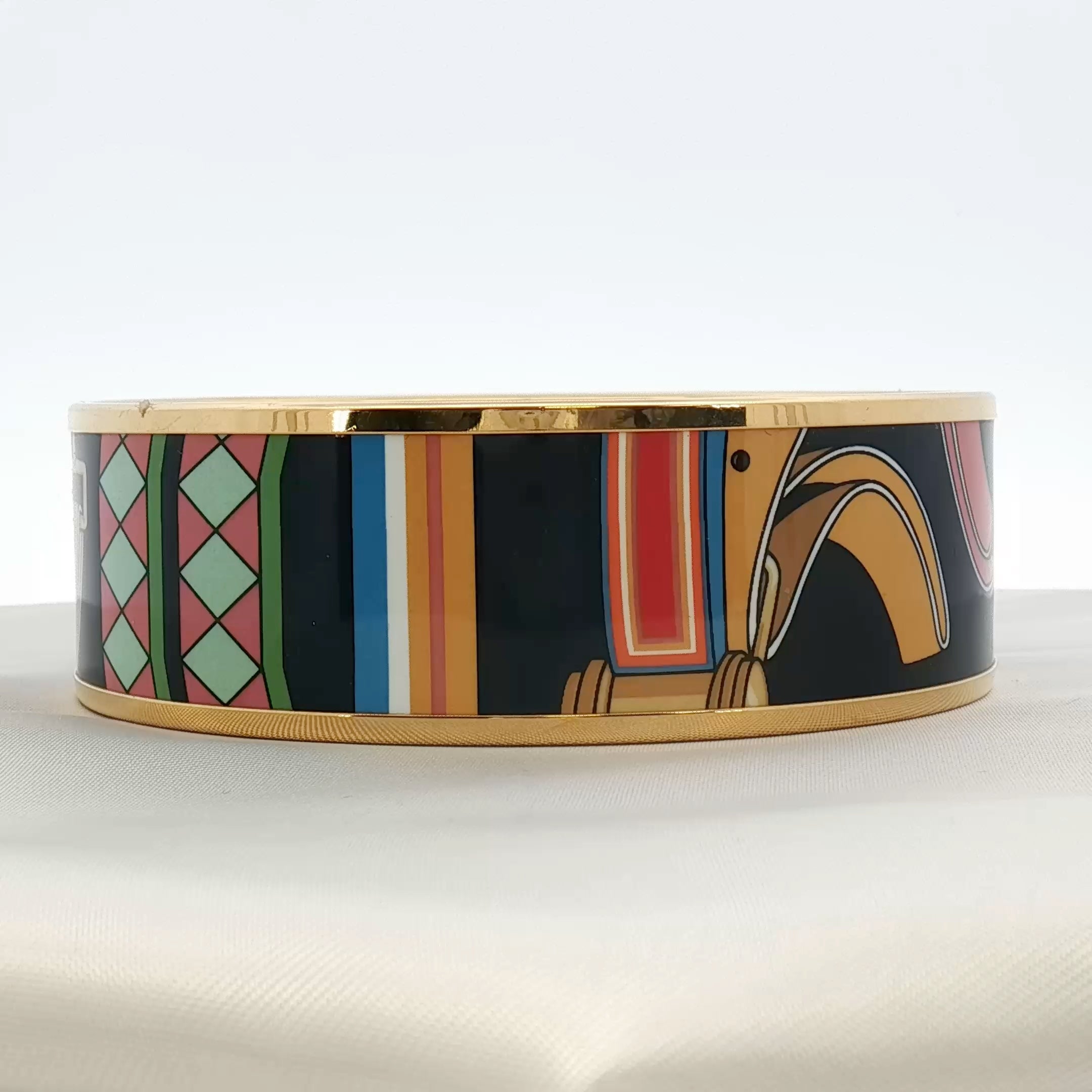 Hermès enamel bangle bracelet from Gold & Beyond, showcasing colorful enamel design and sleek jewelry style.