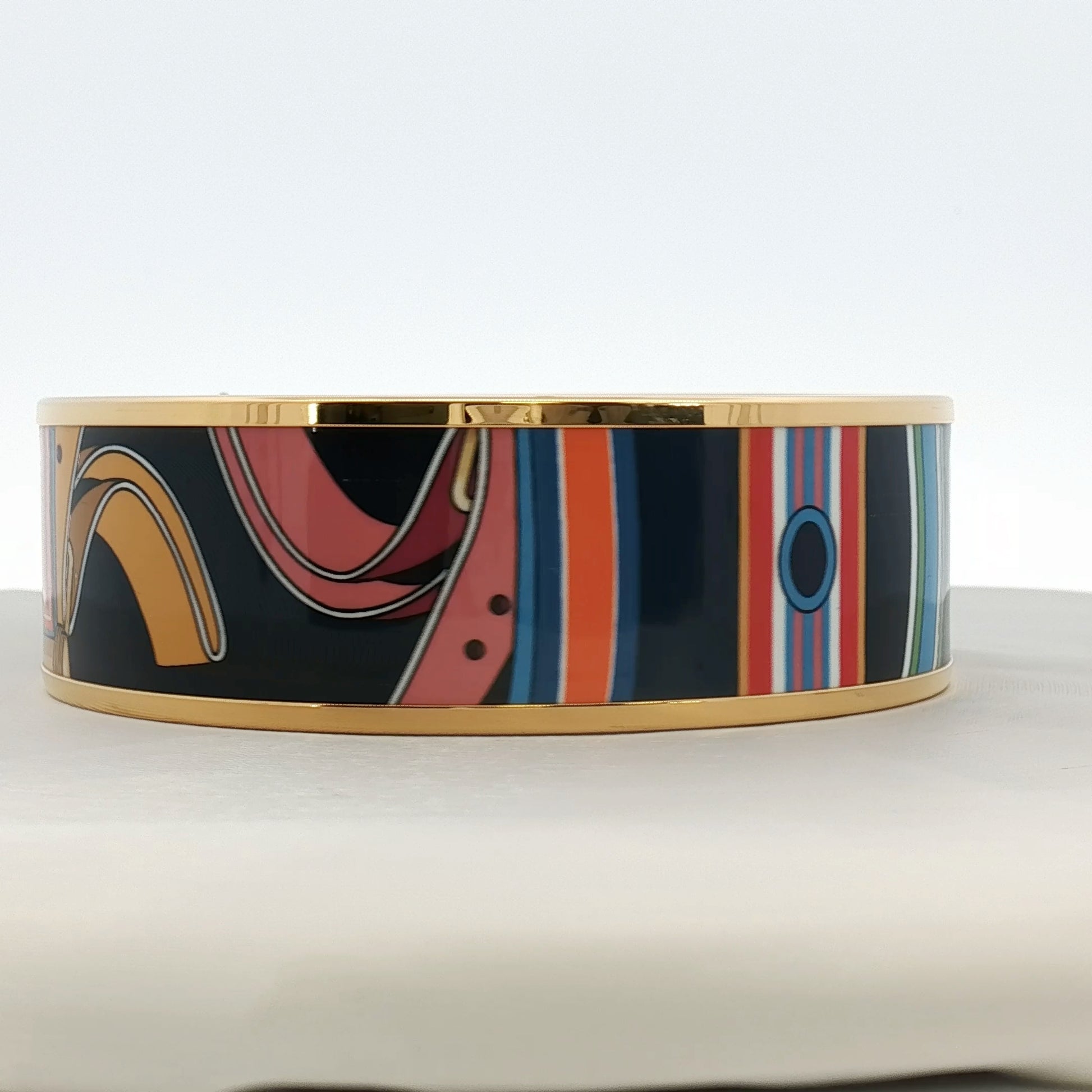 Hermès enamel bangle bracelet with colorful design, crafted jewelry piece from Gold & Beyond.