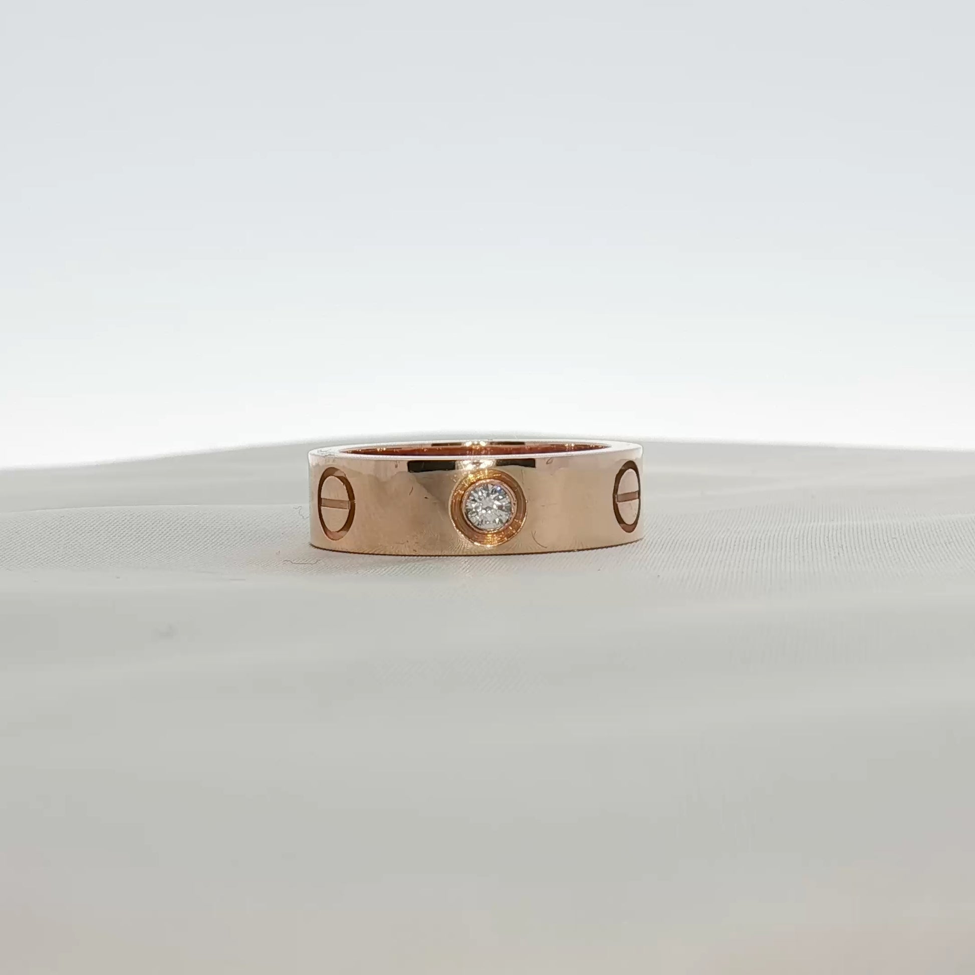 Cartier Love Diamond Ring featuring gold band and sparkling diamonds, elegant jewelry piece from Gold & Beyond.