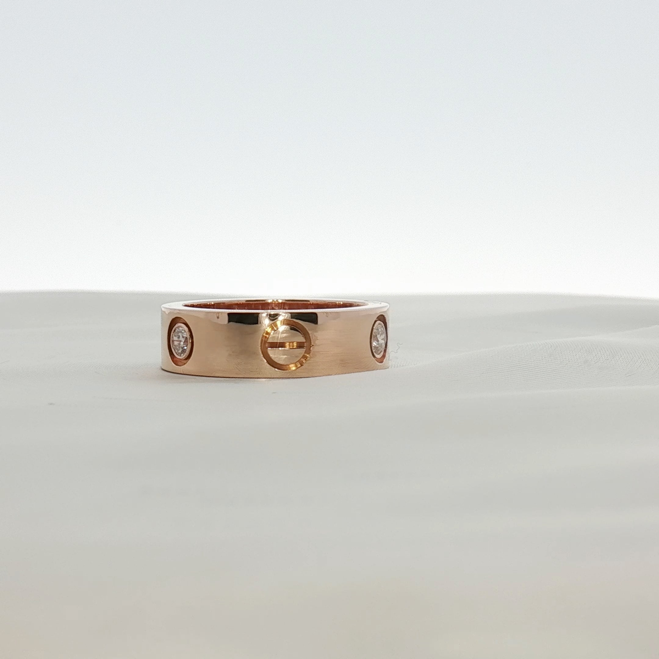 Cartier Love Diamond Ring, jewelry piece with gold band and embedded diamonds, showcasing elegant craftsmanship.