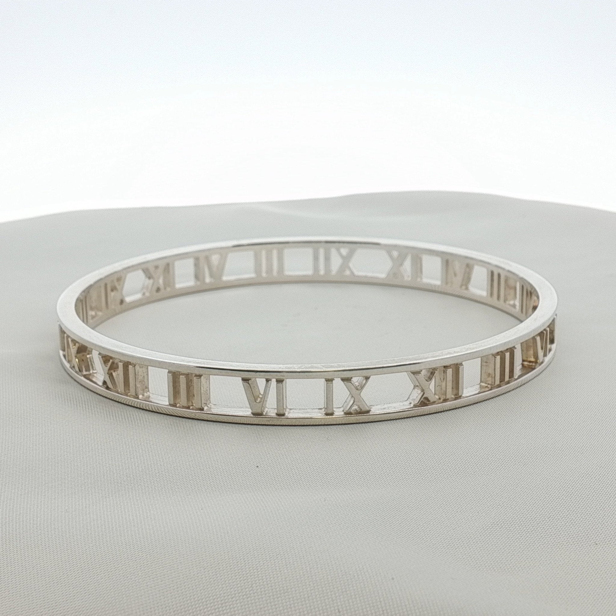 Gold & Beyond Tiffany & Co. Atlas open cuff bracelet featuring sleek, modern jewelry design with engraved detailing.