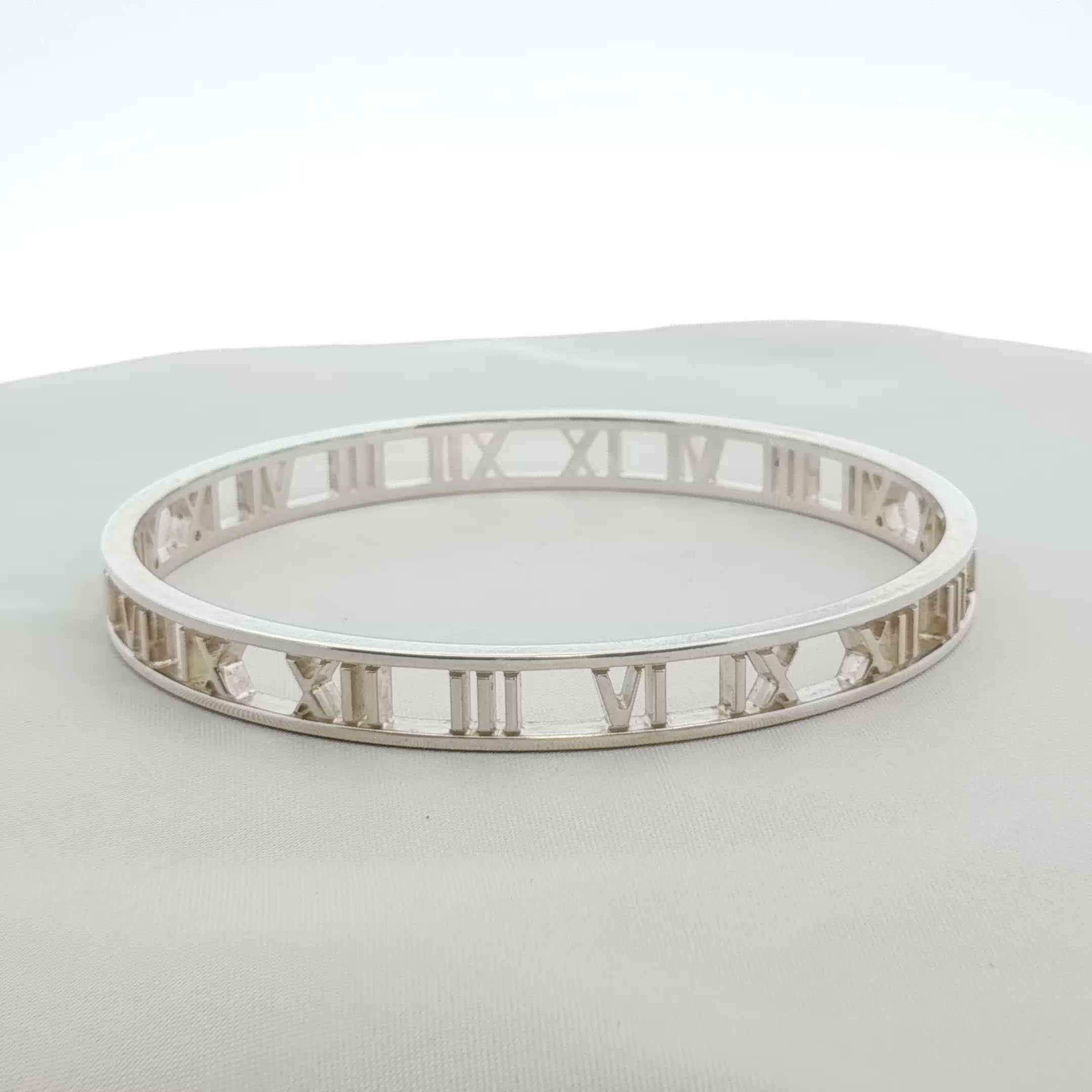 Gold & Beyond Tiffany & Co. Atlas open cuff bracelet in gold jewelry with engraved Roman numeral design, stylish and elegant.