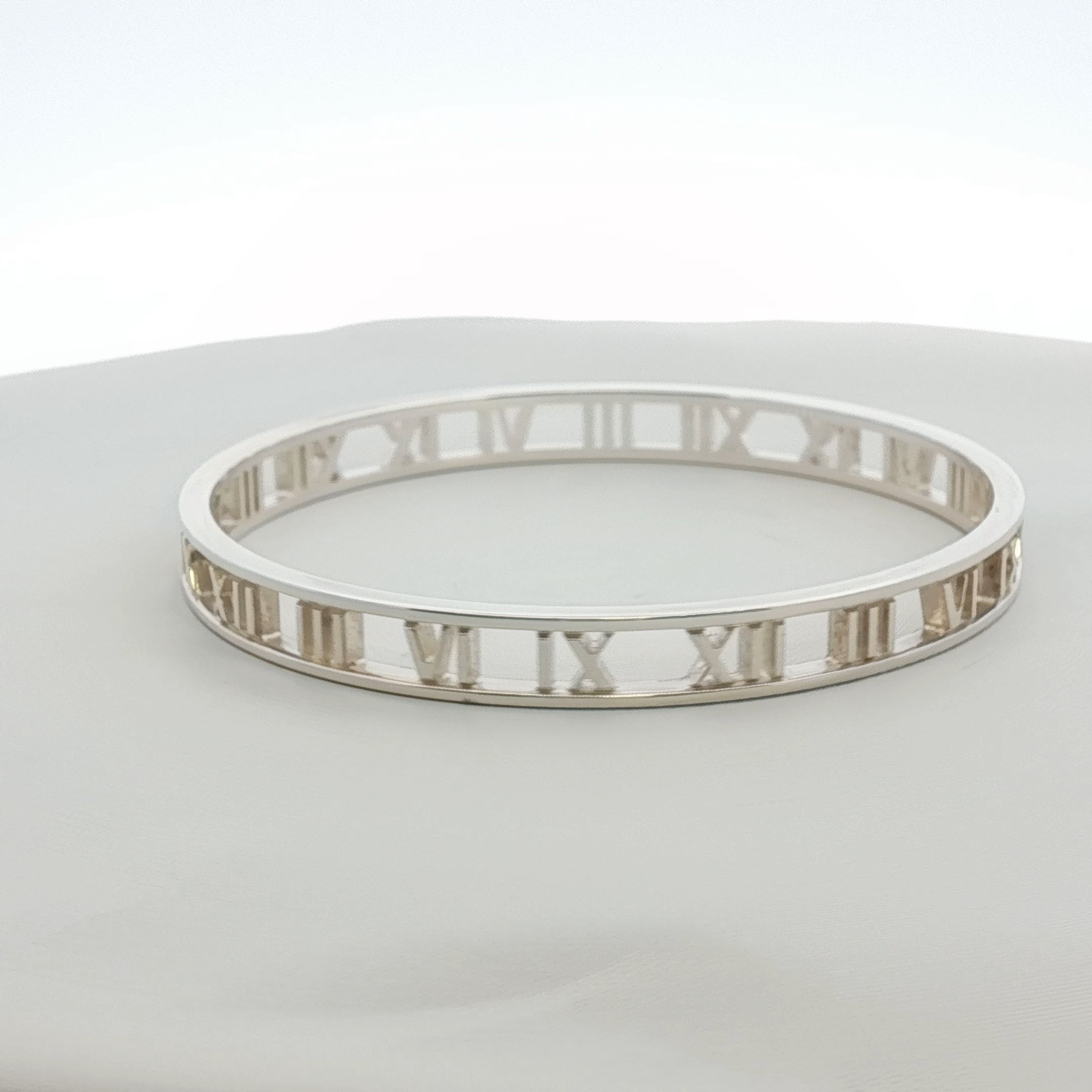 Gold & Beyond Tiffany & Co. Atlas open cuff bracelet jewelry with engraved map design and sleek gold finish.