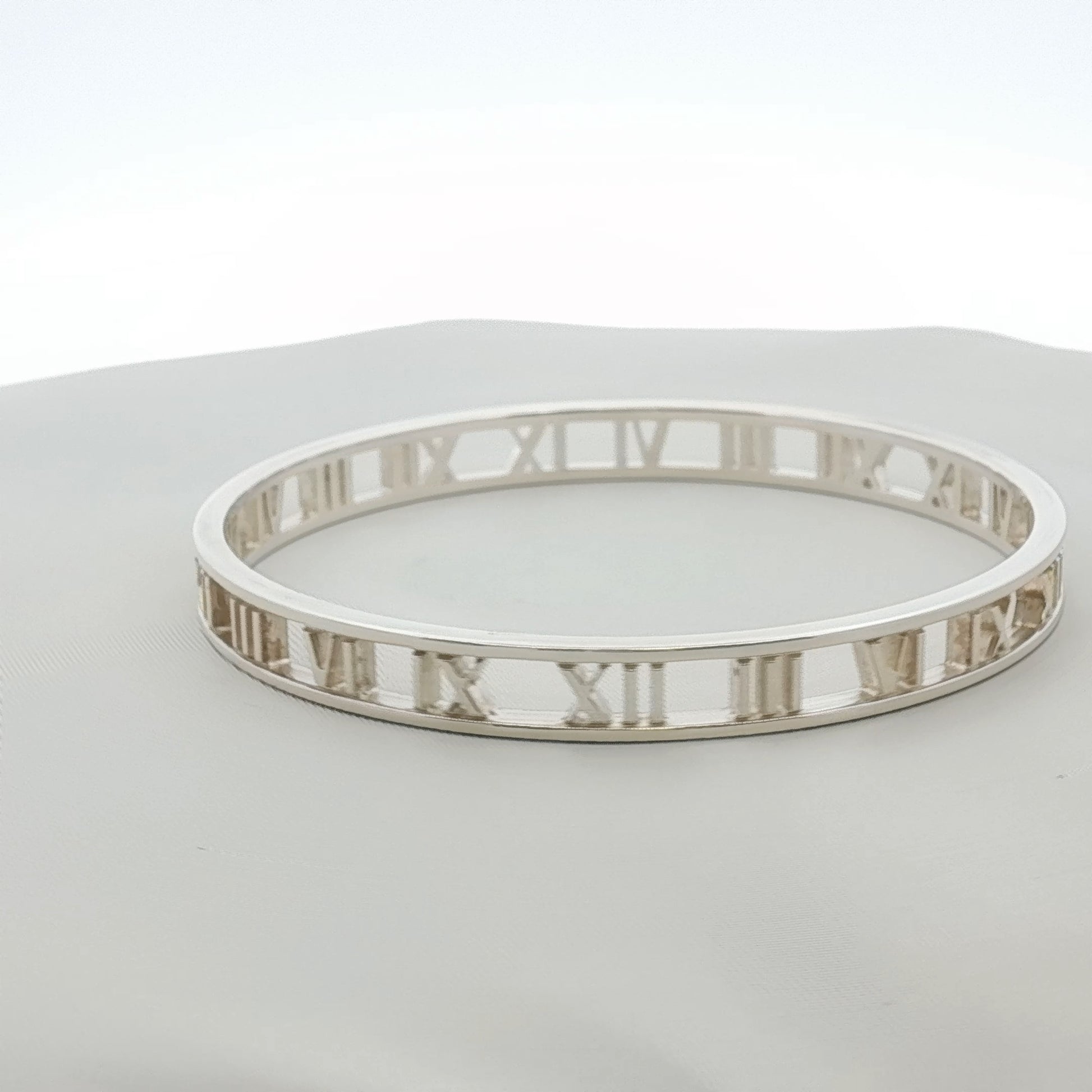 Gold & Beyond Tiffany & Co. Atlas Open Cuff Bracelet in jewelry, featuring a sleek gold design with engraved details.