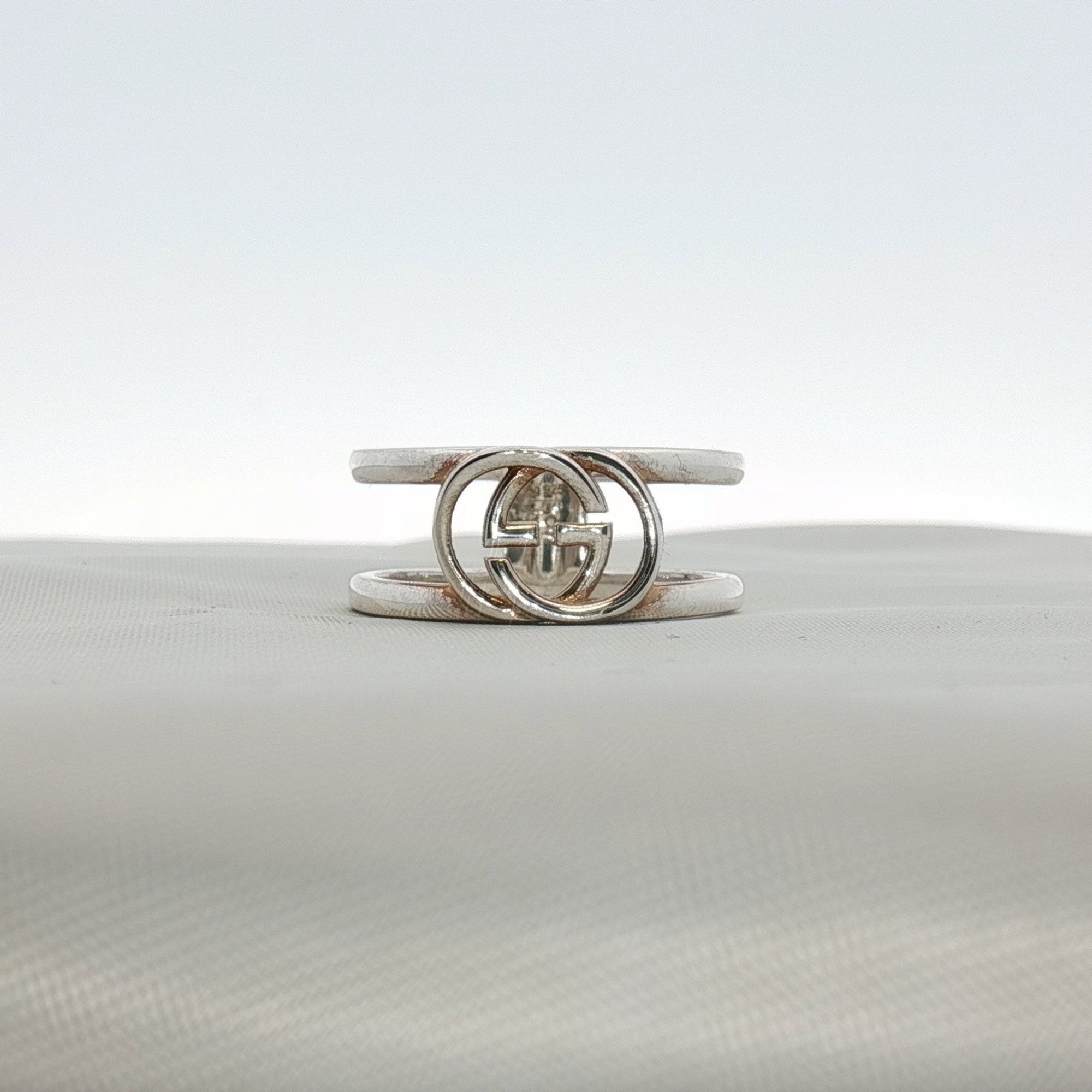 Sterling silver Gucci GG ring, stylish jewelry piece with engraved logo, showcasing elegant design and craftsmanship.