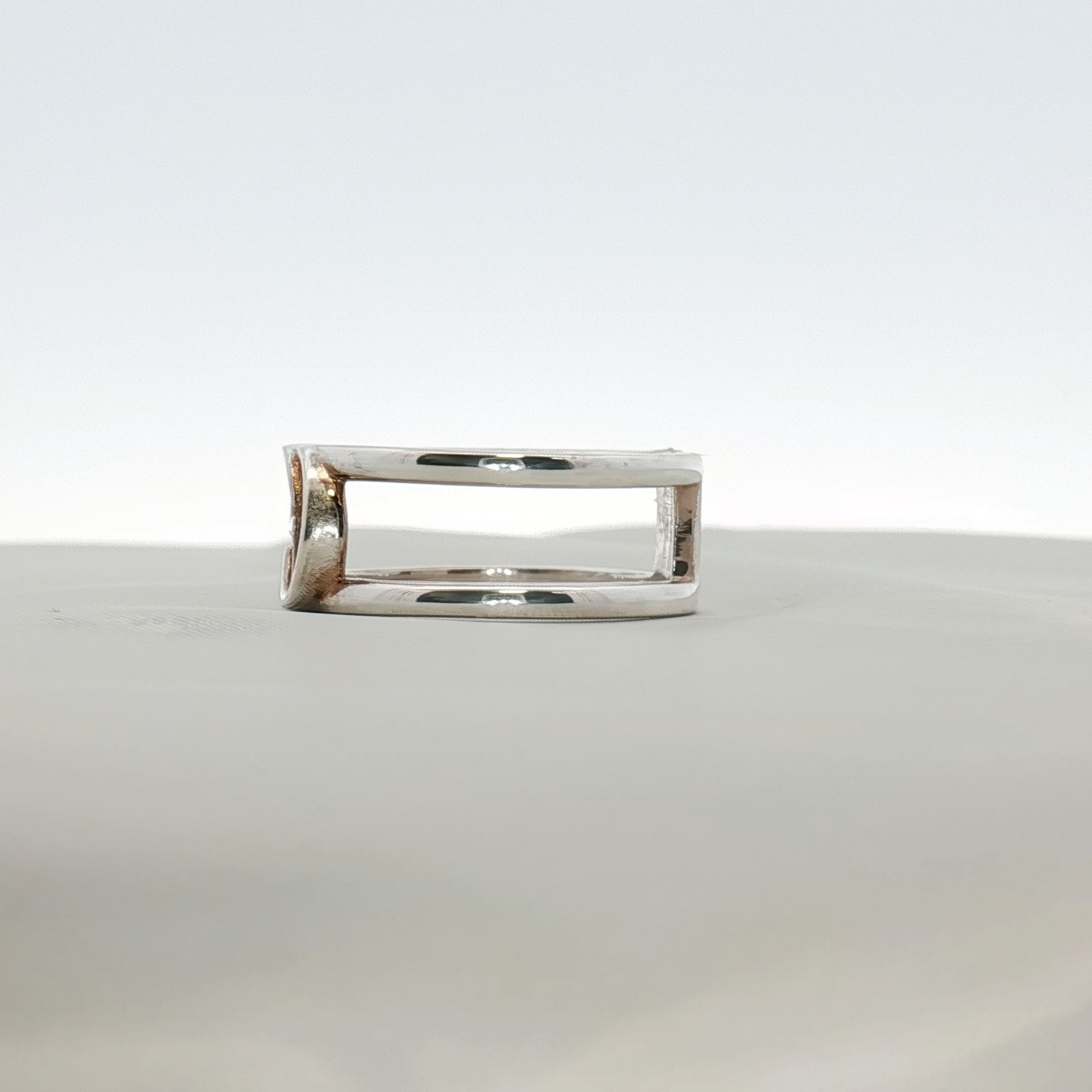 Sterling silver Gucci GG jewelry ring with engraved logo, polished finish, and smooth band, designed for stylish accessories.