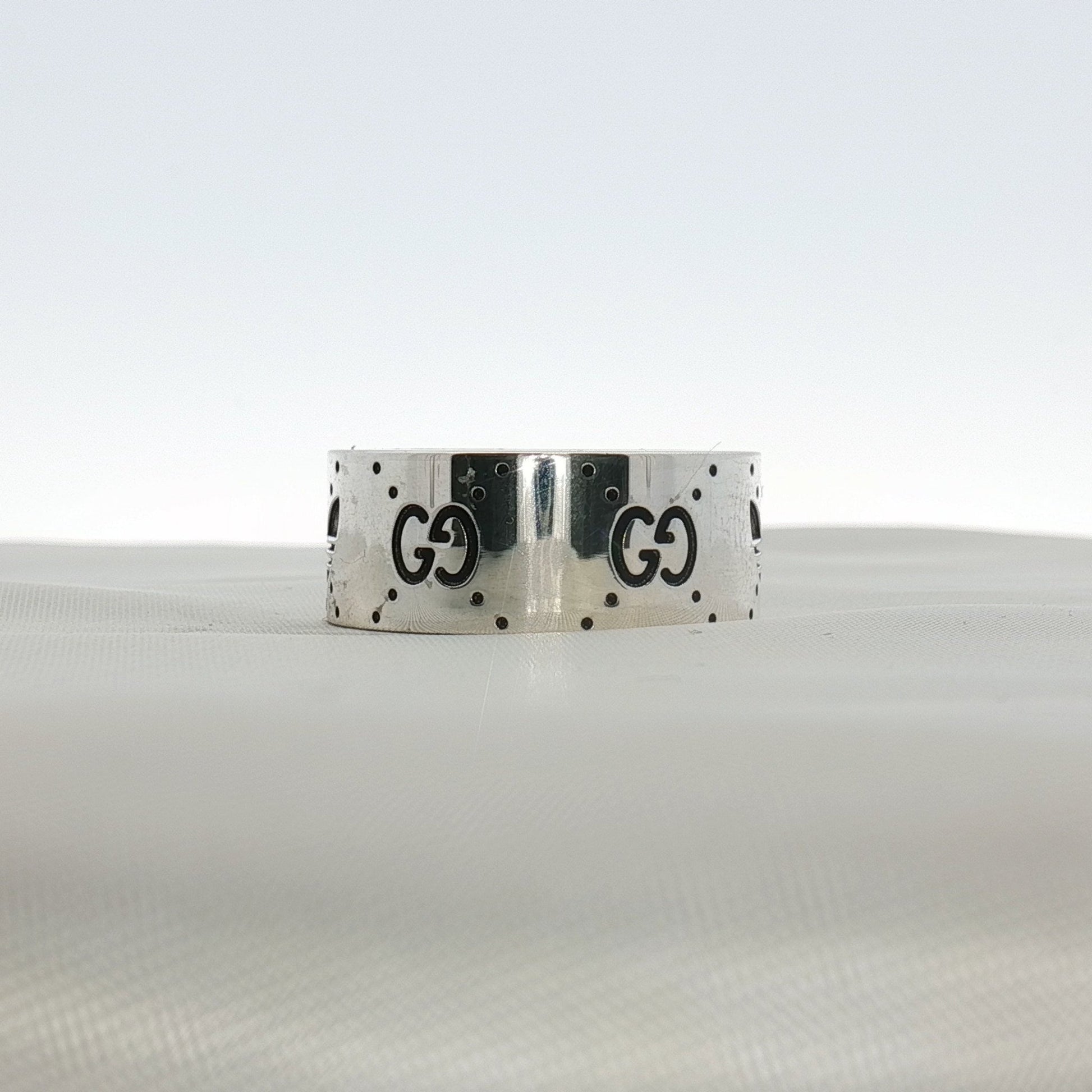 Gucci x Adidas logo band ring in gold-tone jewelry with interlocking brand logos, stylish and modern accessory.