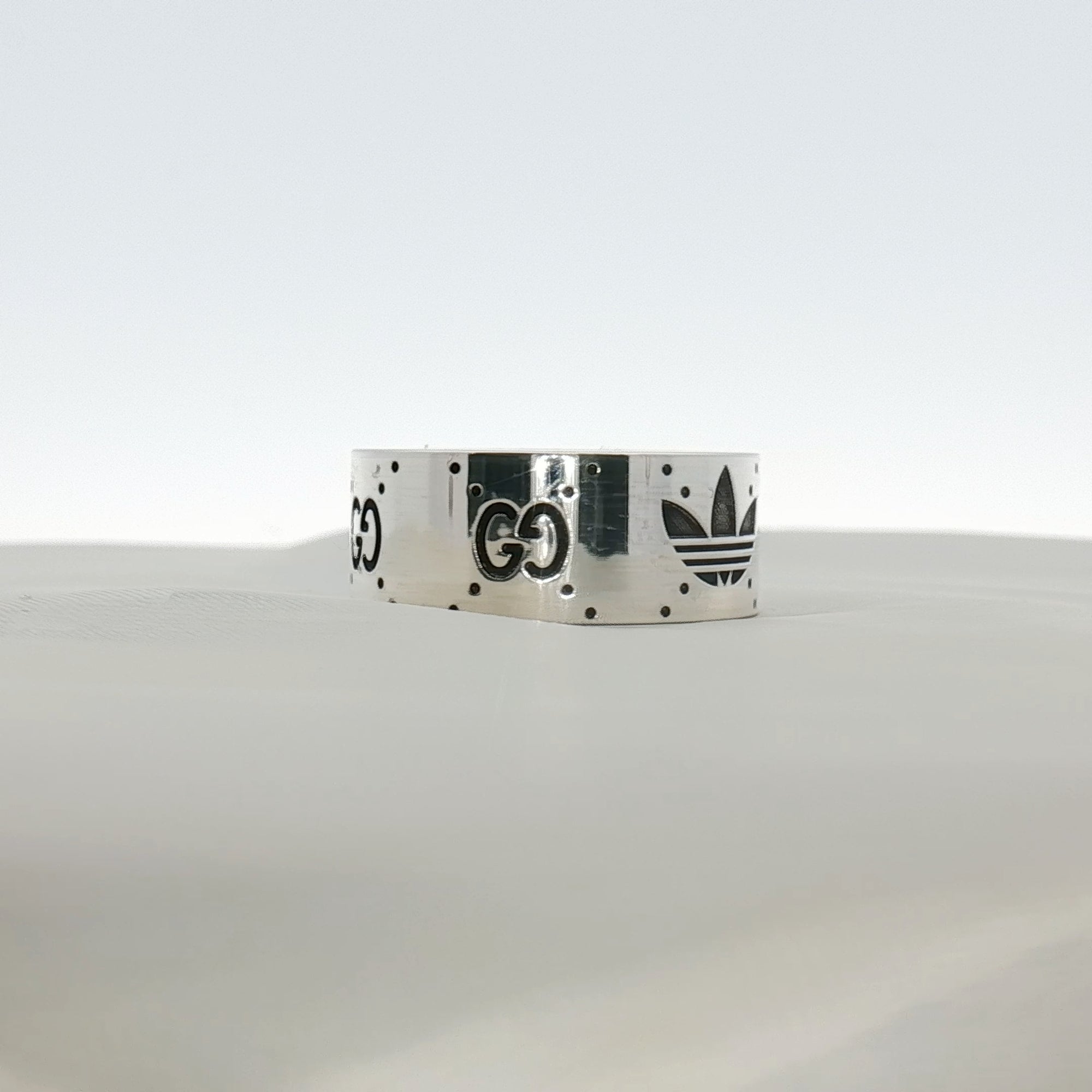 Gold & Beyond Gucci x Adidas logo band ring, stylish jewelry featuring the iconic logo design on a sleek band.