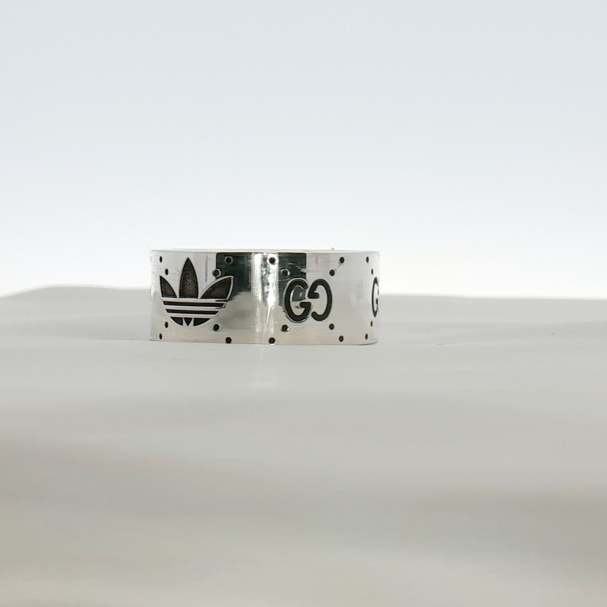 Gucci x Adidas logo band ring in gold jewelry with iconic brand logos on a sleek band design