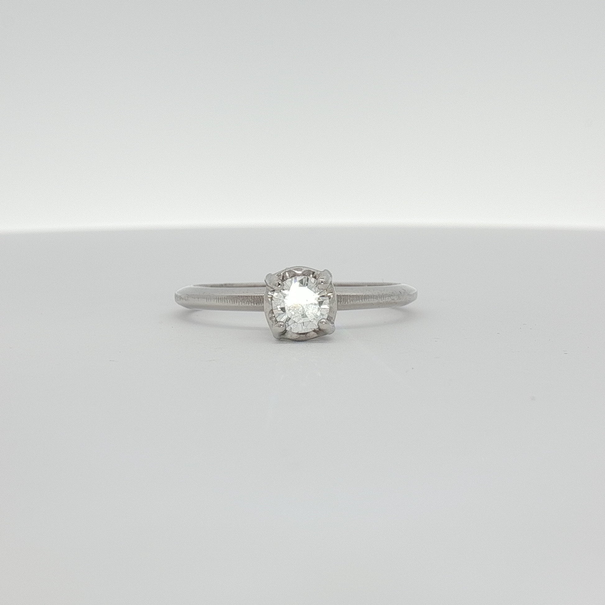 14K white gold diamond solitaire ring featuring a single sparkling diamond, elegant jewelry piece from Gold & Beyond.