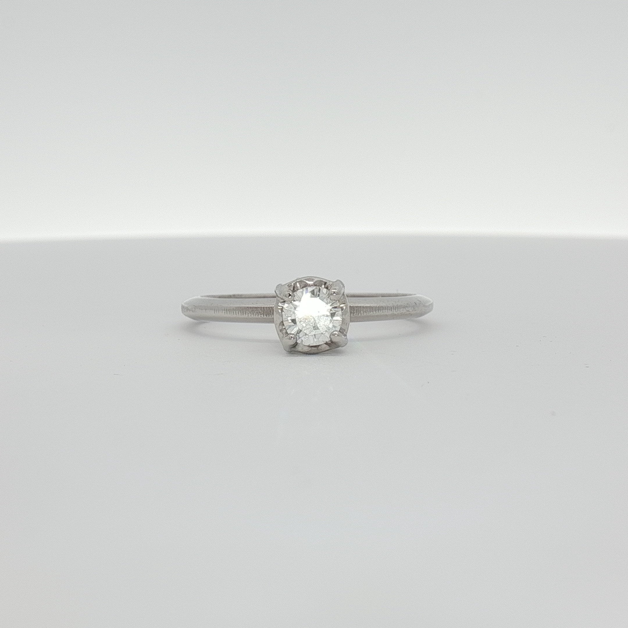 14K white gold diamond solitaire ring with a central sparkling diamond, elegant jewelry piece from Gold & Beyond.