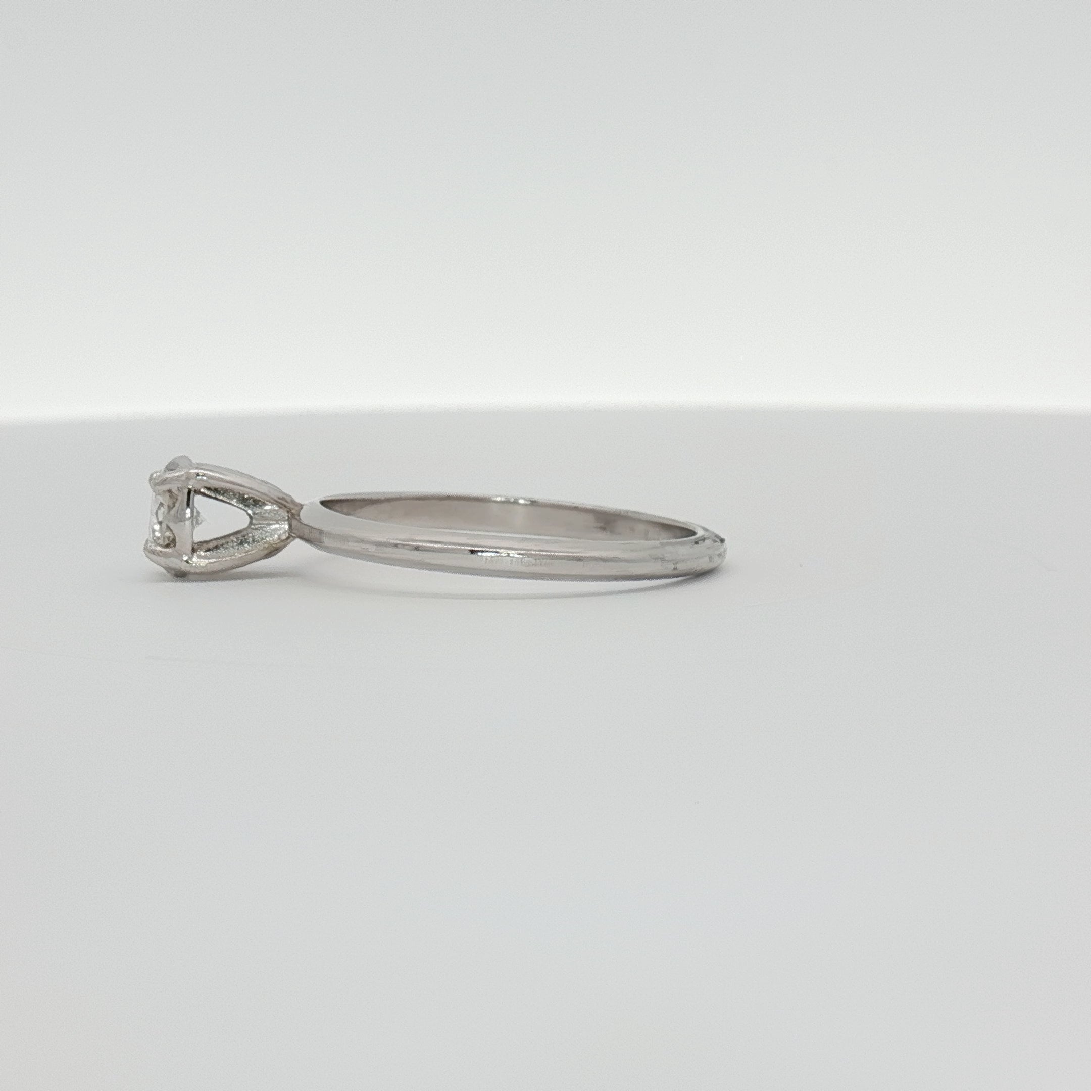 14K white gold diamond solitaire ring with a sparkling center stone, showcasing elegant jewelry design by Gold & Beyond.