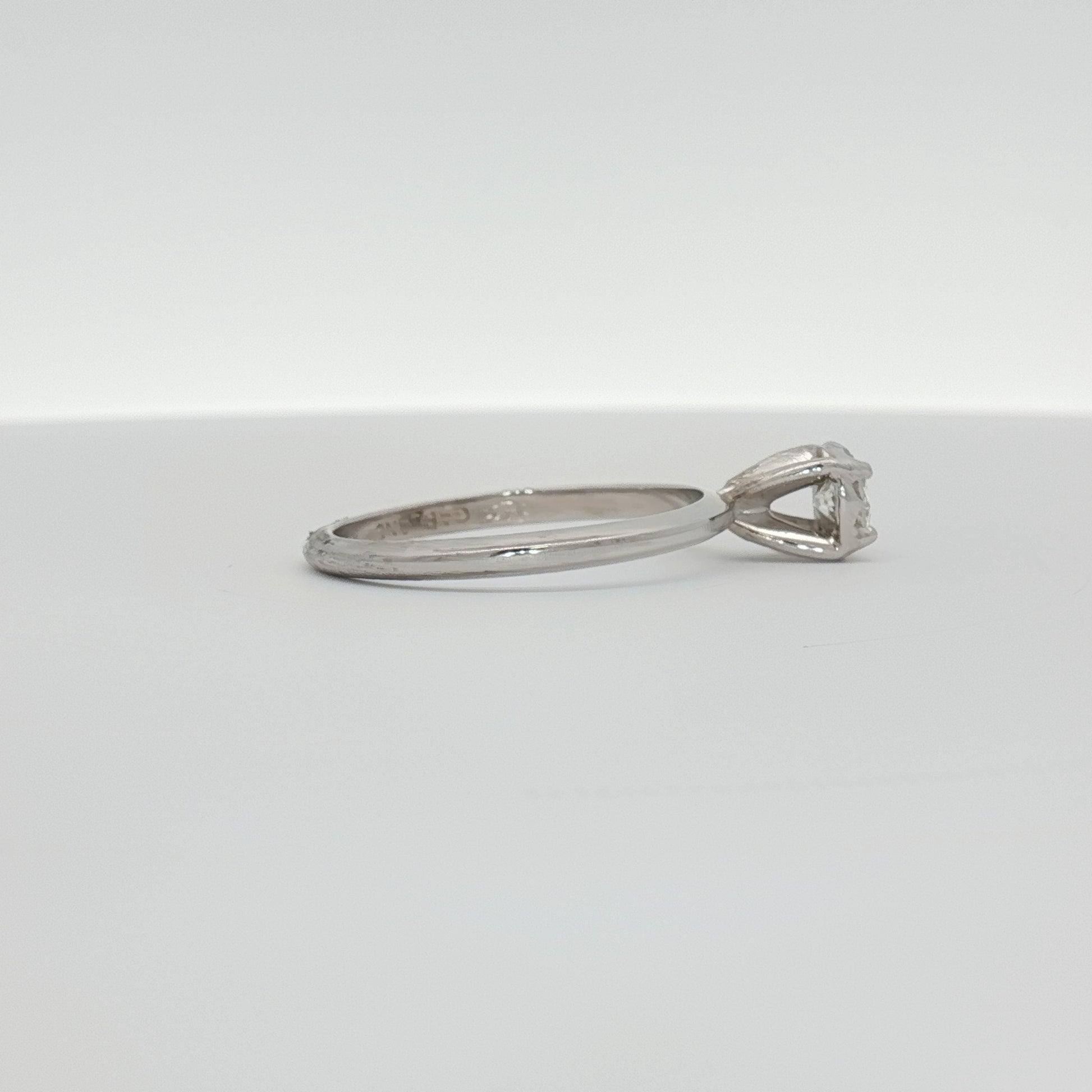 14K white gold diamond solitaire ring with a round center stone, elegant jewelry piece from Gold & Beyond.