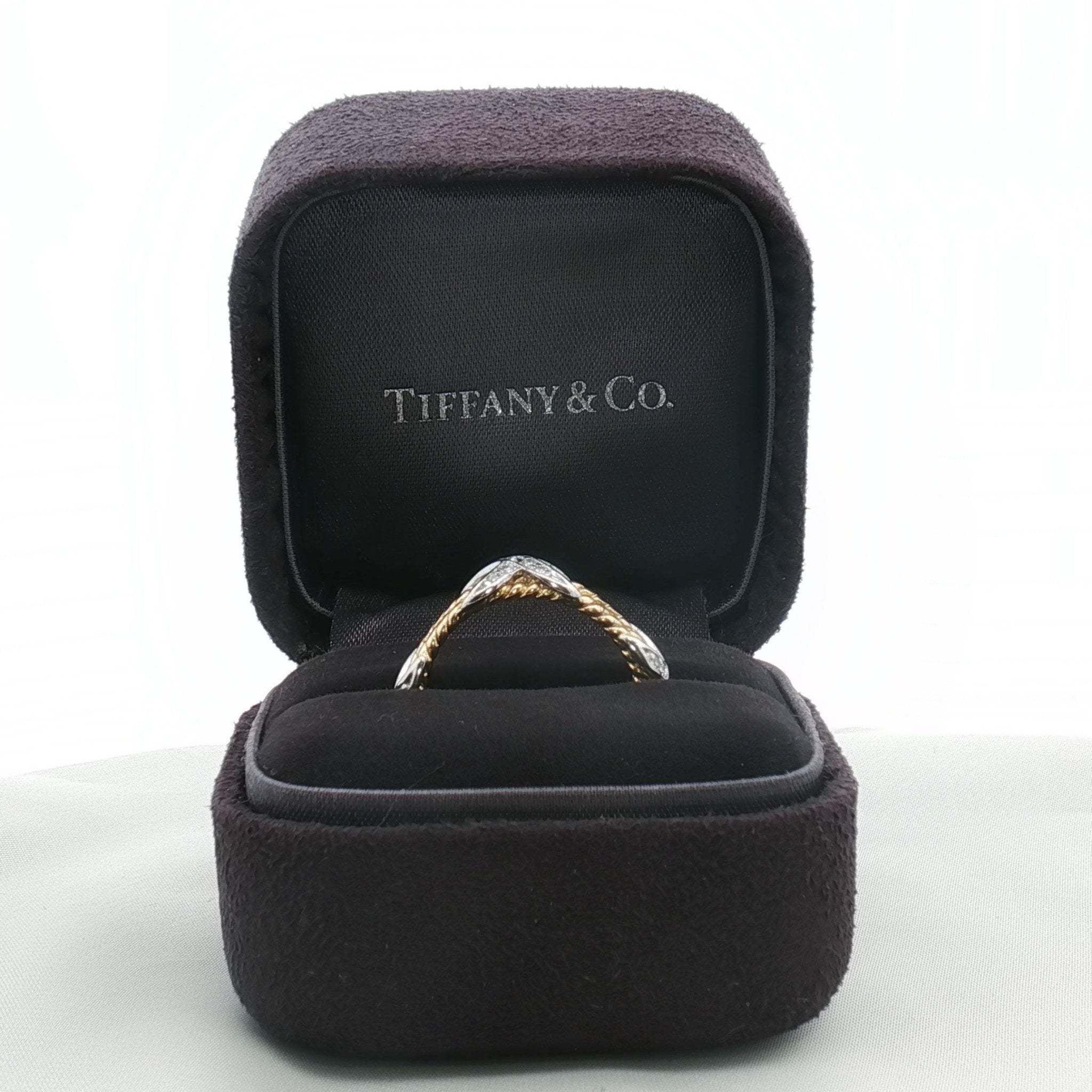 Tiffany & Co. Schlumberger three-row rope diamond ring in gold, featuring sparkling diamonds and intricate rope design.