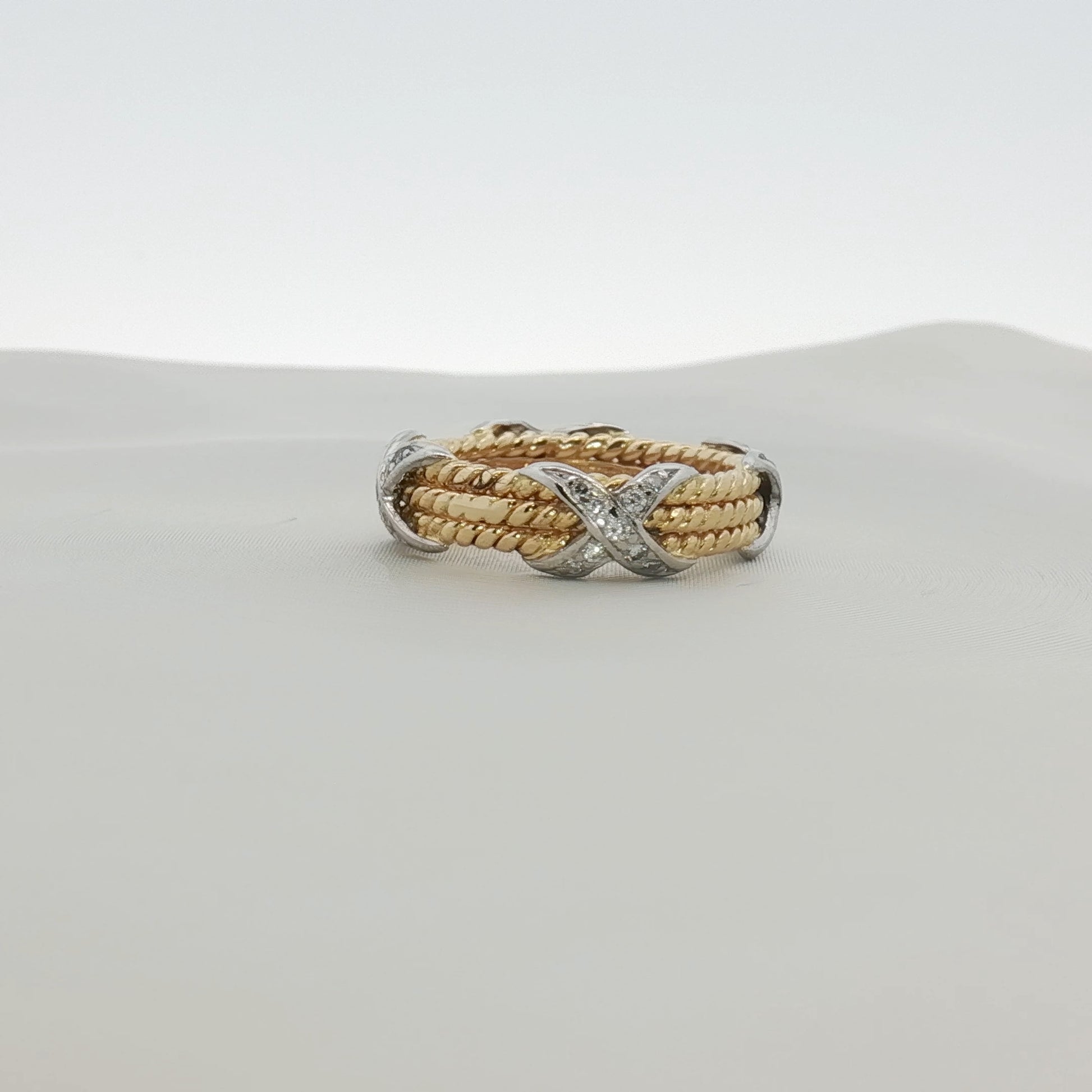 Tiffany & Co. Schlumberger three-row rope diamond ring in gold, showcasing intricate design and sparkling diamonds.