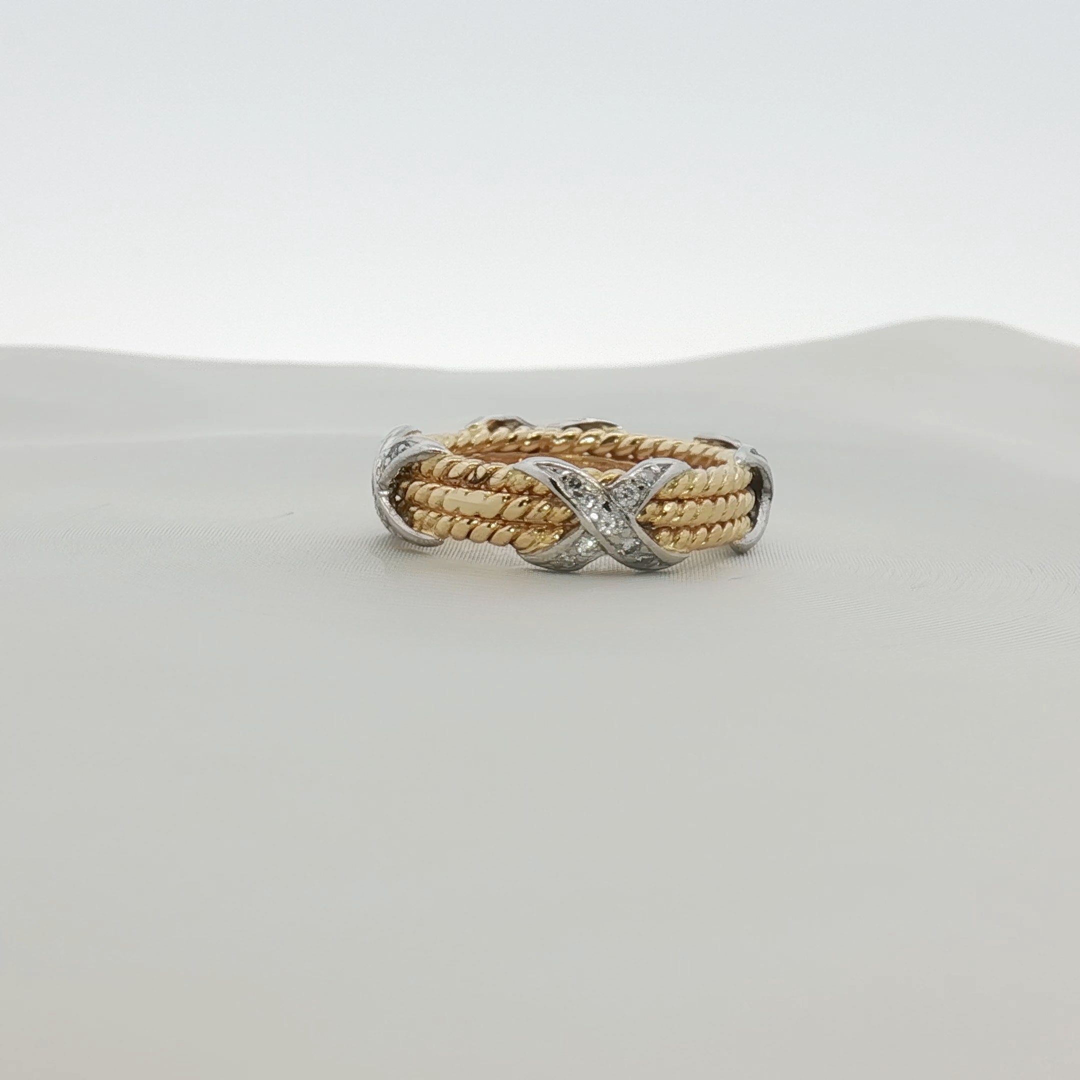 Tiffany & Co. Schlumberger three-row rope diamond ring in gold, showcasing intricate design and sparkling diamonds.