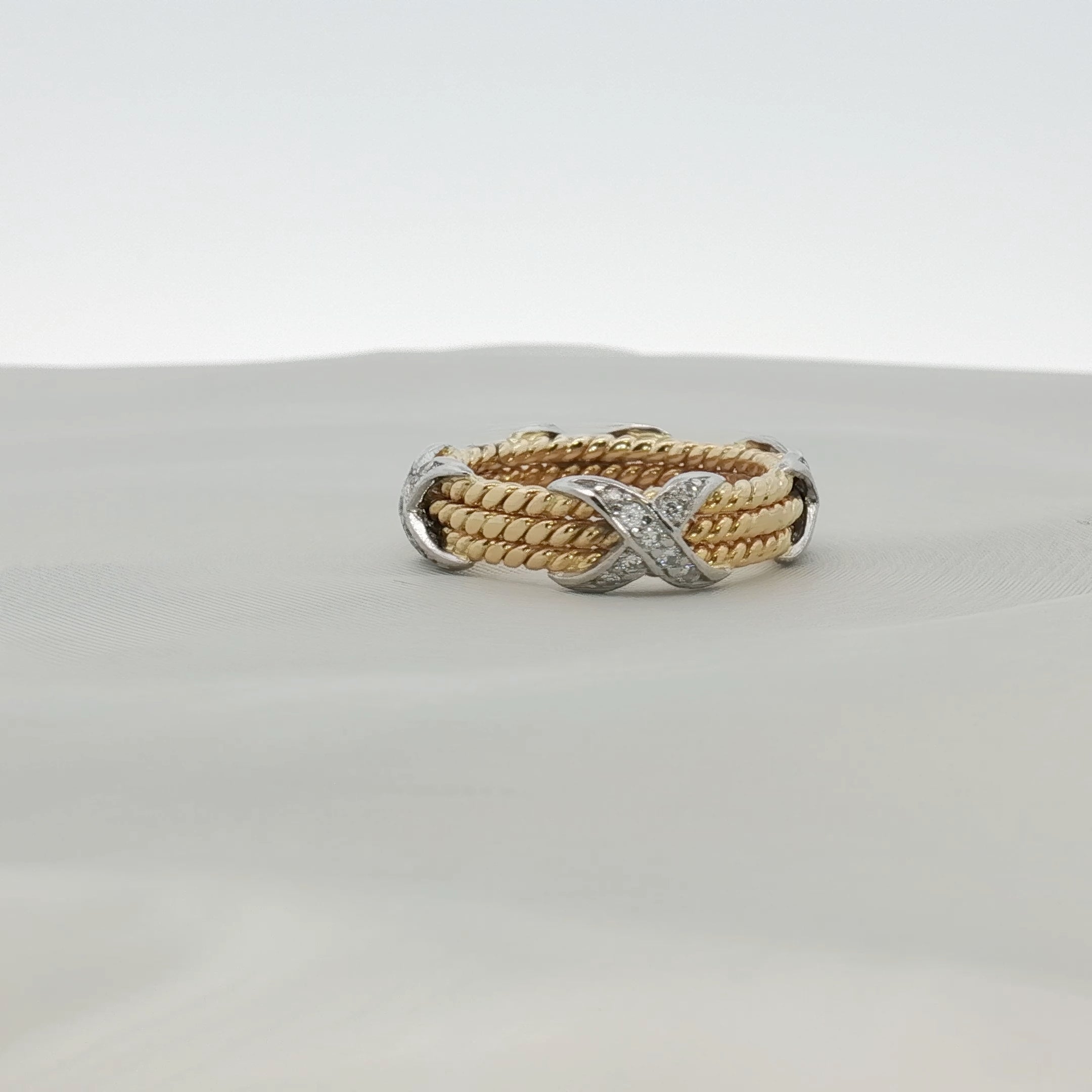 Tiffany & Co. Schlumberger three-row rope diamond ring, elegant gold jewelry featuring sparkling diamonds.