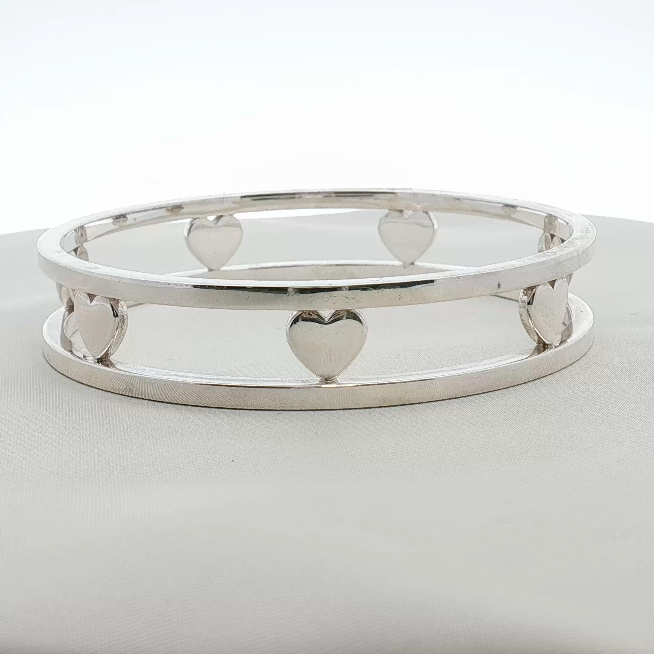 Sterling silver Tiffany & Co. heart bracelet with delicate chain, jewelry piece by Gold & Beyond, on a white background.