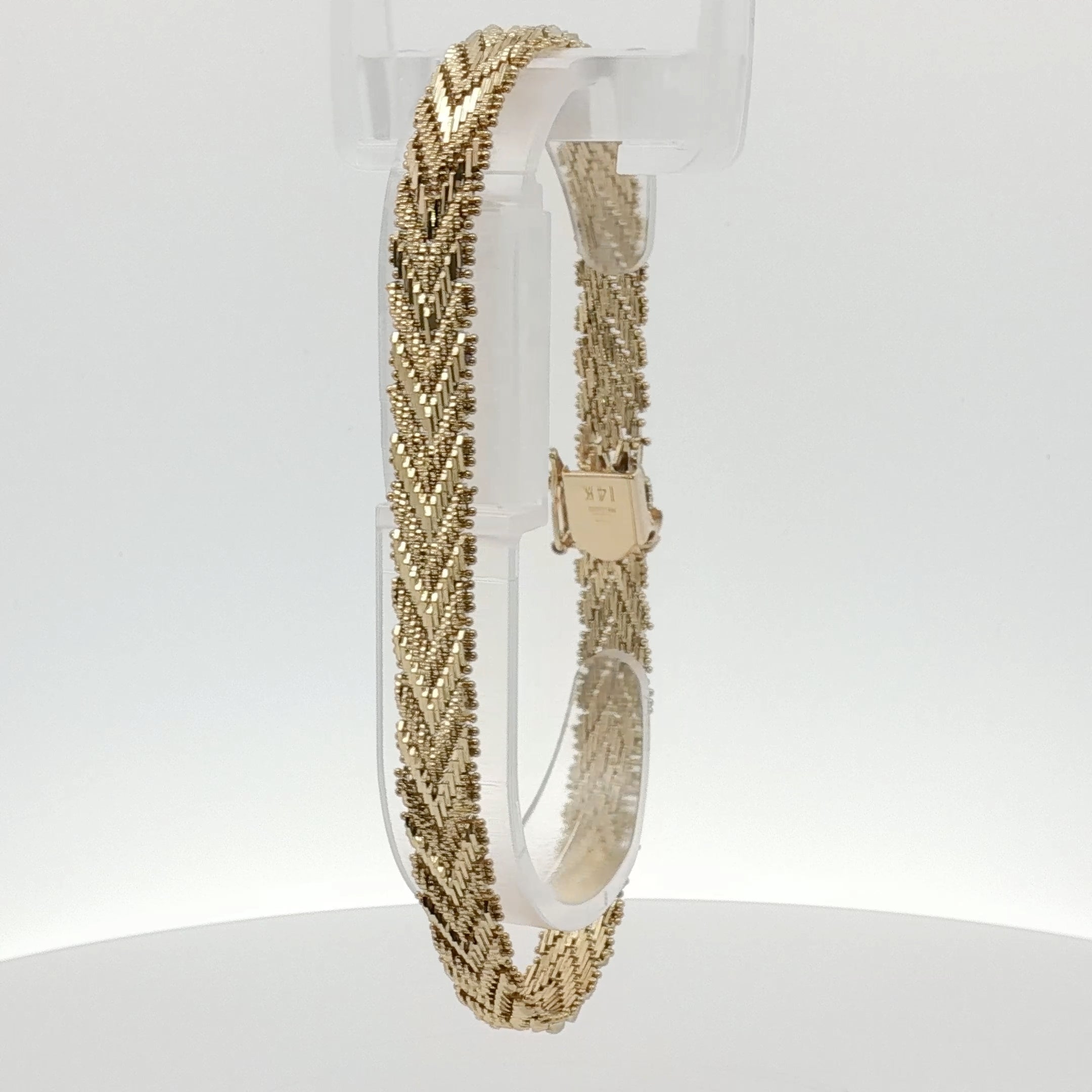 14K yellow gold textured link bracelet with a polished jewelry finish, showcasing interconnected links.