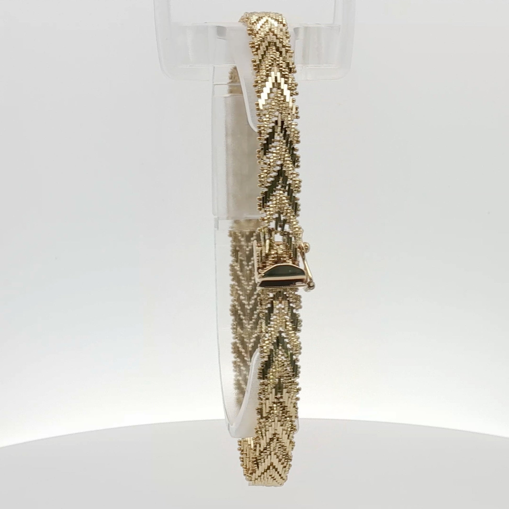 14K yellow gold textured link bracelet showcasing polished, interconnected gold links in a jewelry display.