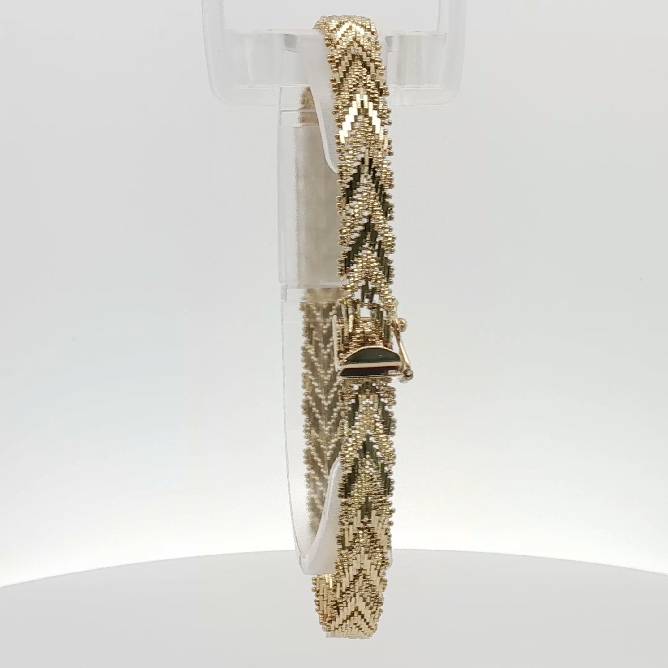 14K yellow gold textured link bracelet showcasing polished, interconnected gold links in a jewelry display.