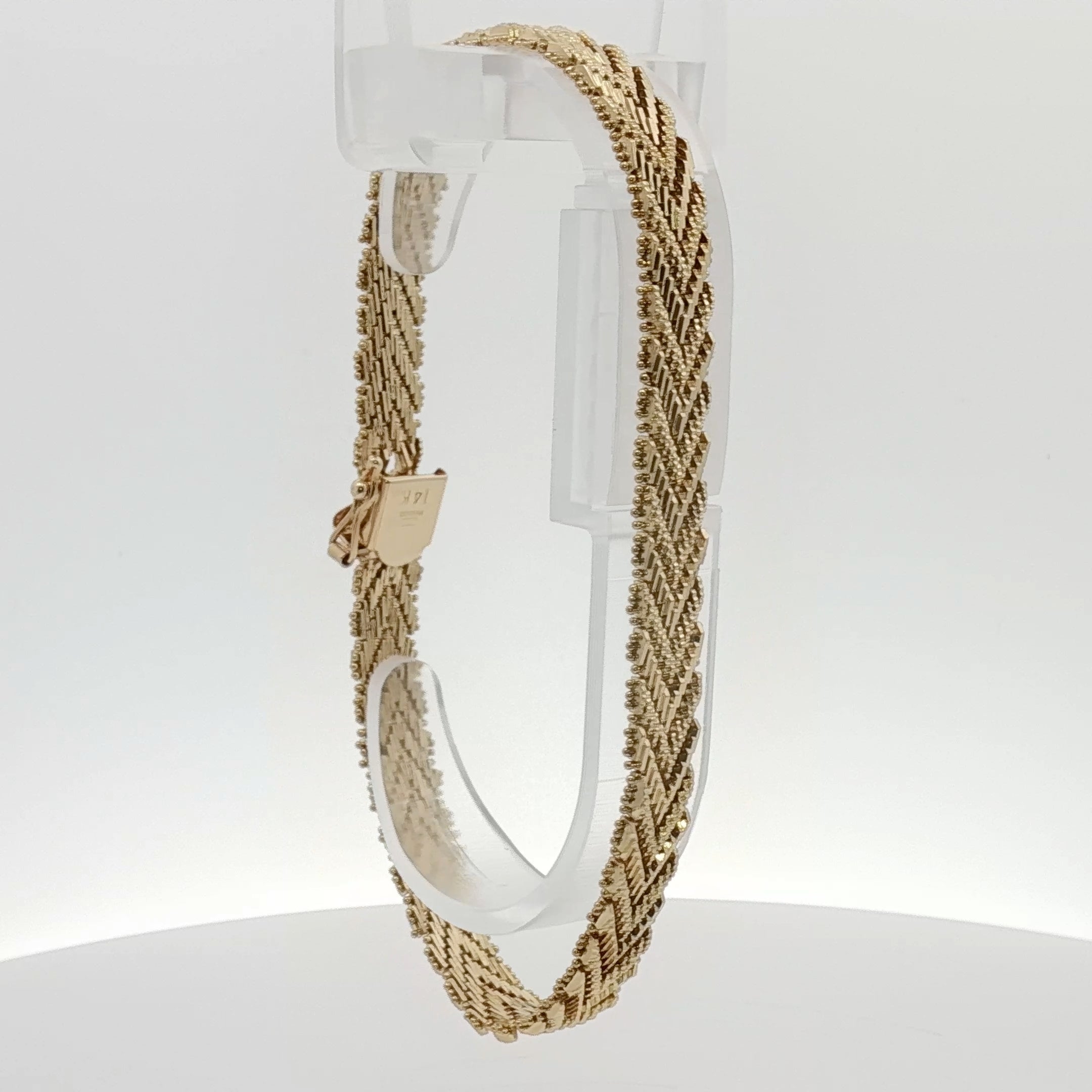 14K yellow gold textured link bracelet with a bold, stylish design, showcasing intricate craftsmanship and a polished finish.