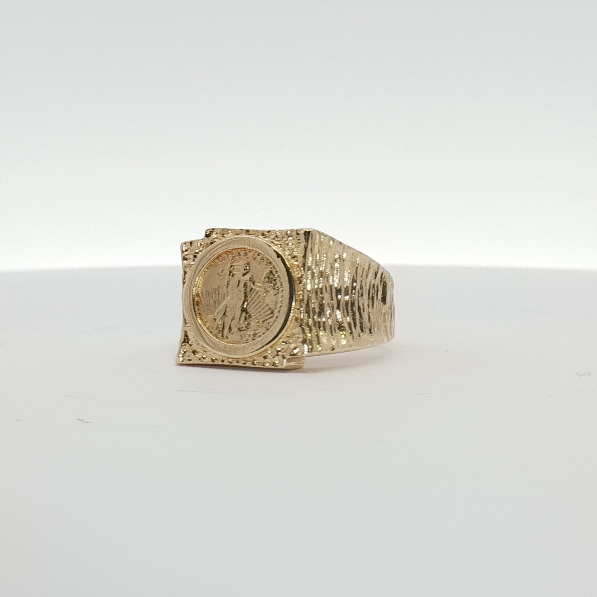 14K yellow gold coin ring from Gold & Beyond featuring a detailed engraved coin design on a smooth band.