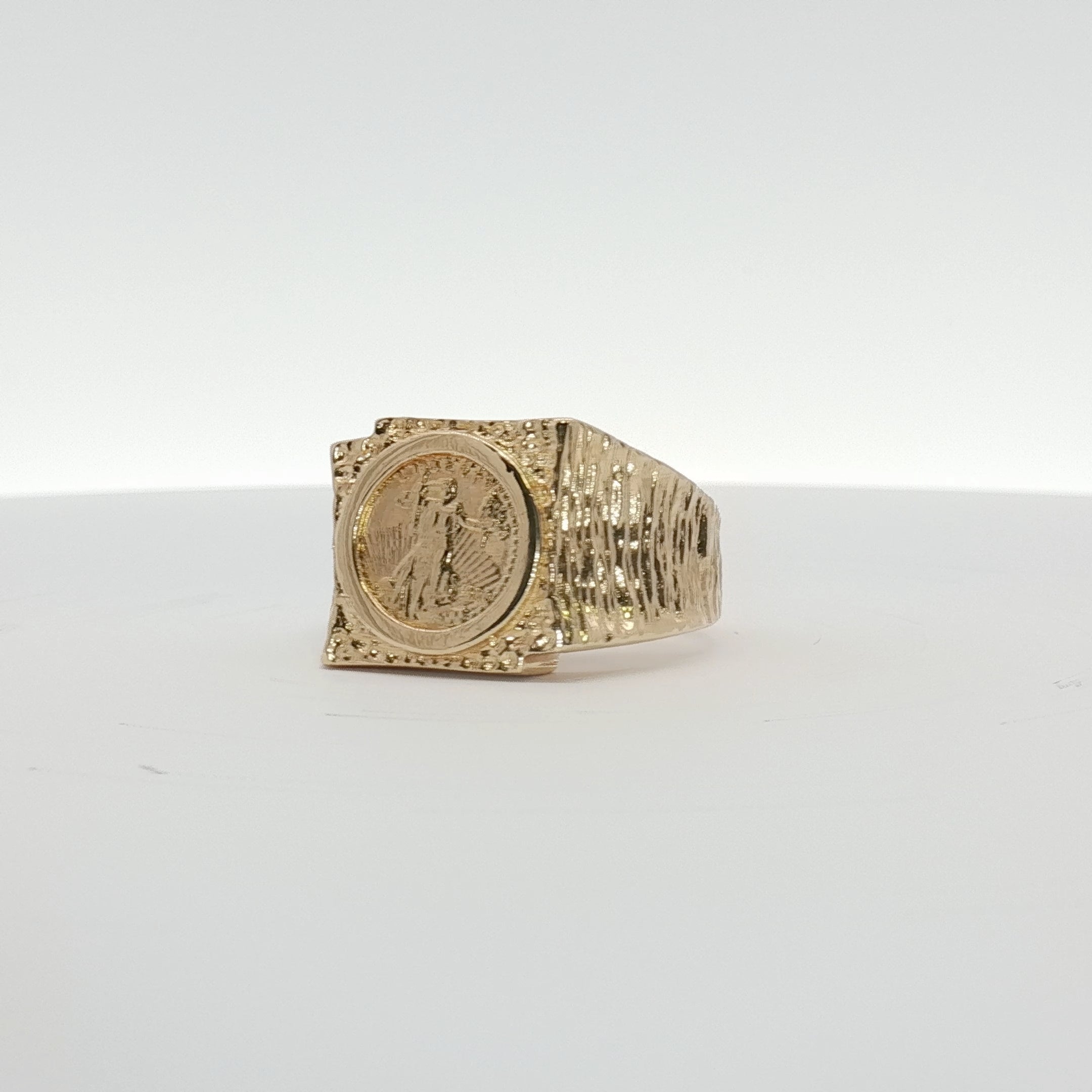 14K yellow gold coin ring from Gold & Beyond featuring a detailed engraved coin design on a smooth band.