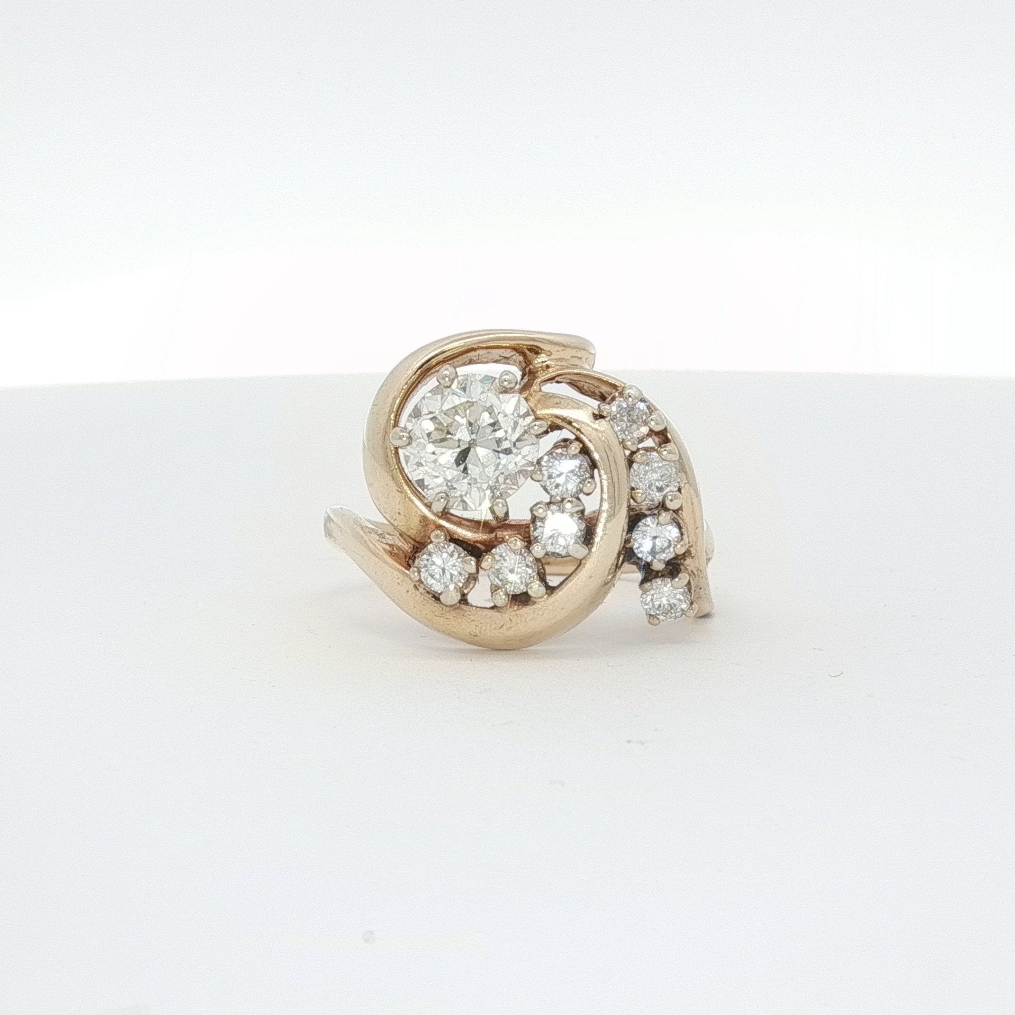14K yellow gold diamond swirl ring with sparkling diamonds and elegant design, crafted by Gold & Beyond.